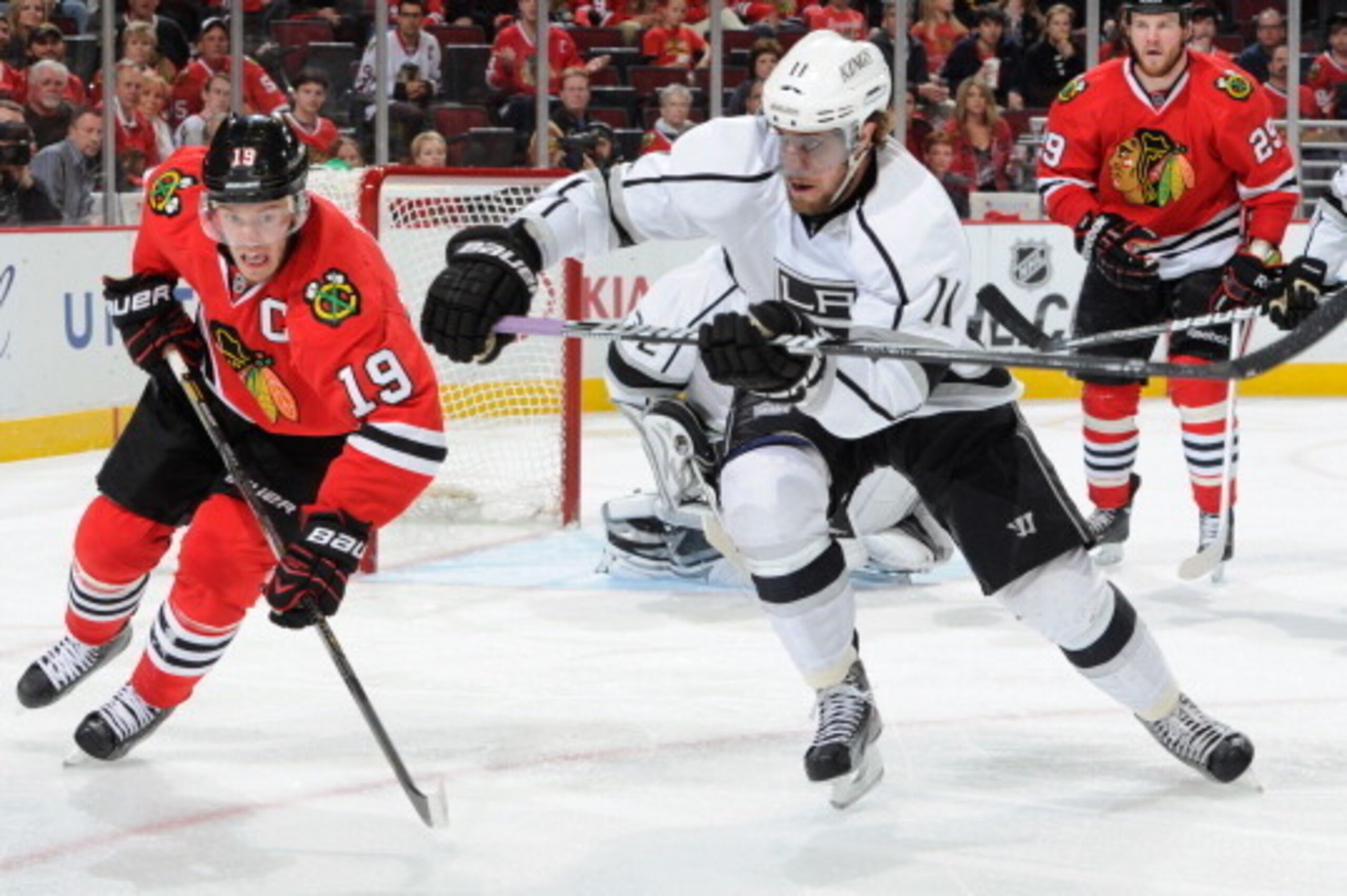 CHICAGO, IL - JUNE 8: Jonathan Toews #19 of the Chicago Blackhawks and Anze Kopitar #11 of the Los Angeles Kings skate across the ice as Bryan Bickell #29 of the Blackhawks watches in the background in Game Five of the Western Conference Final during the 