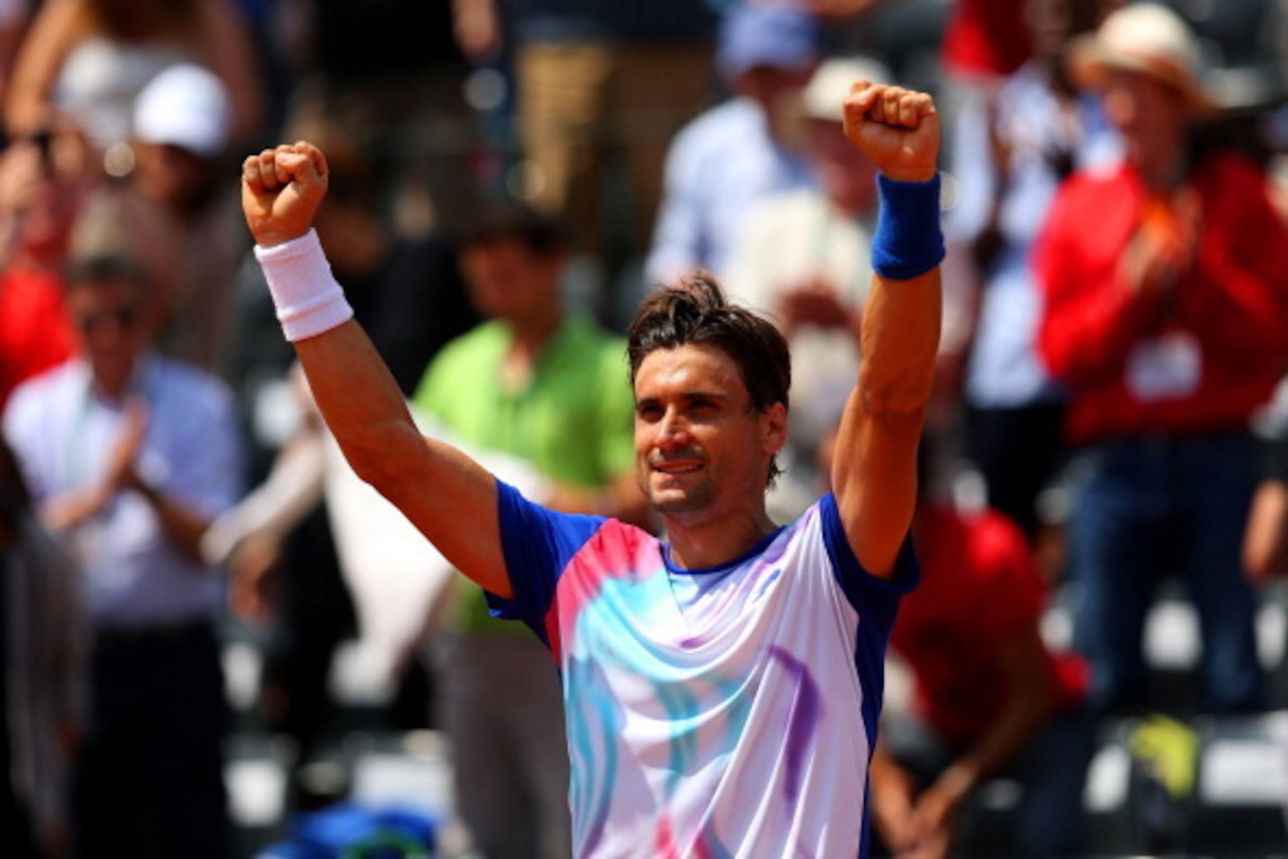 PARIS, FRANCE - MAY 31:  David Ferrer of Spain celebrates victory in his men's singles match against Andreas Seppi of Italy on day seven of the French Open at Roland Garros on May 31, 2014 in Paris, France.  (Photo by Clive Brunskill/Getty Images)