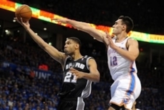 May 25, 2014; Oklahoma City, OK, USA; San Antonio Spurs forward Tim Duncan (21) attempts a shot against Oklahoma City Thunder center Steven Adams (12) during the third quarter in game three of the Western Conference Finals of the 2014 NBA Playoffs at Ches