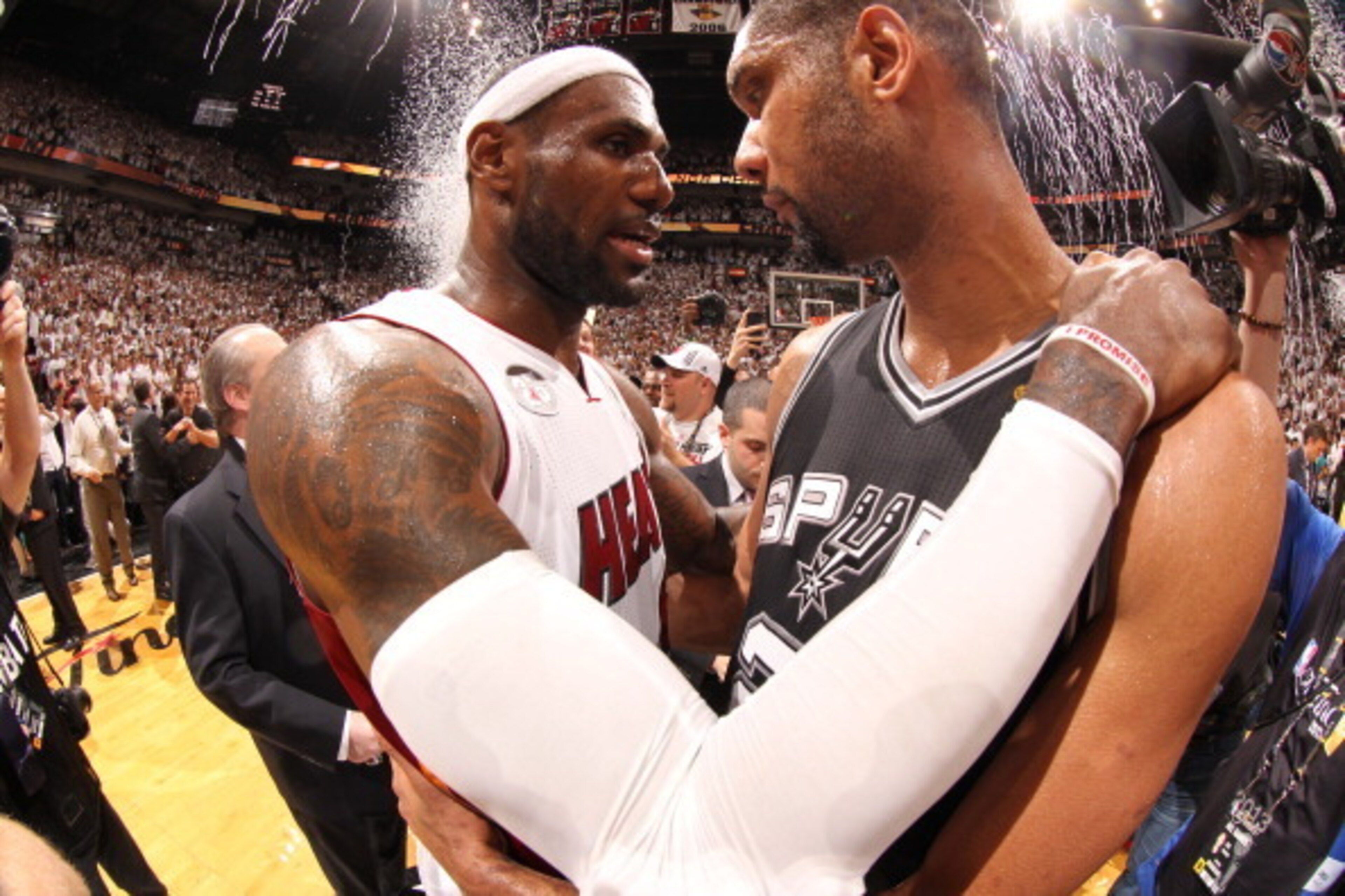 MIAMI, FL - JUNE 20: LeBron James #6 of the Miami Heat with Tim Duncan #21 of the San Antonio Spurs at the end of Game Seven of the 2013 NBA Finals on June 20, 2013 at American Airlines Arena in Miami, Florida. NOTE TO USER: User expressly acknowledges an MIAMI, FL - JUNE 20: LeBron James #6 of the Miami Heat with Tim Duncan #21 of the San Antonio Spurs at the end of Game Seven of the 2013 NBA Finals on June 20, 2013 at American Airlines Arena in Miami, Florida. NOTE TO USER: User expressly acknowledges an