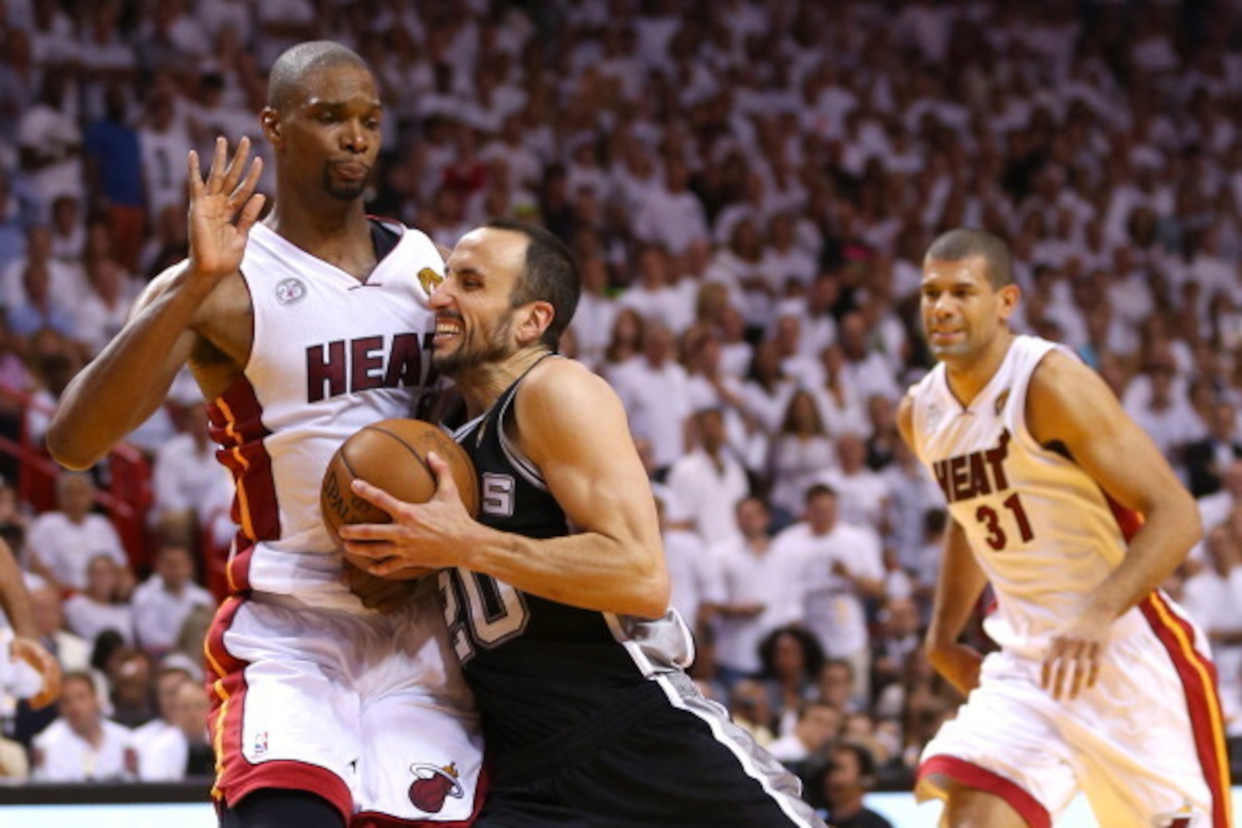 MIAMI, FL - JUNE 20:  Manu Ginobili #20 of the San Antonio Spurs drives on Chris Bosh #1 of the Miami Heat in the fourth quarter during Game Seven of the 2013 NBA Finals at AmericanAirlines Arena on June 20, 2013 in Miami, Florida. NOTE TO USER: User expr