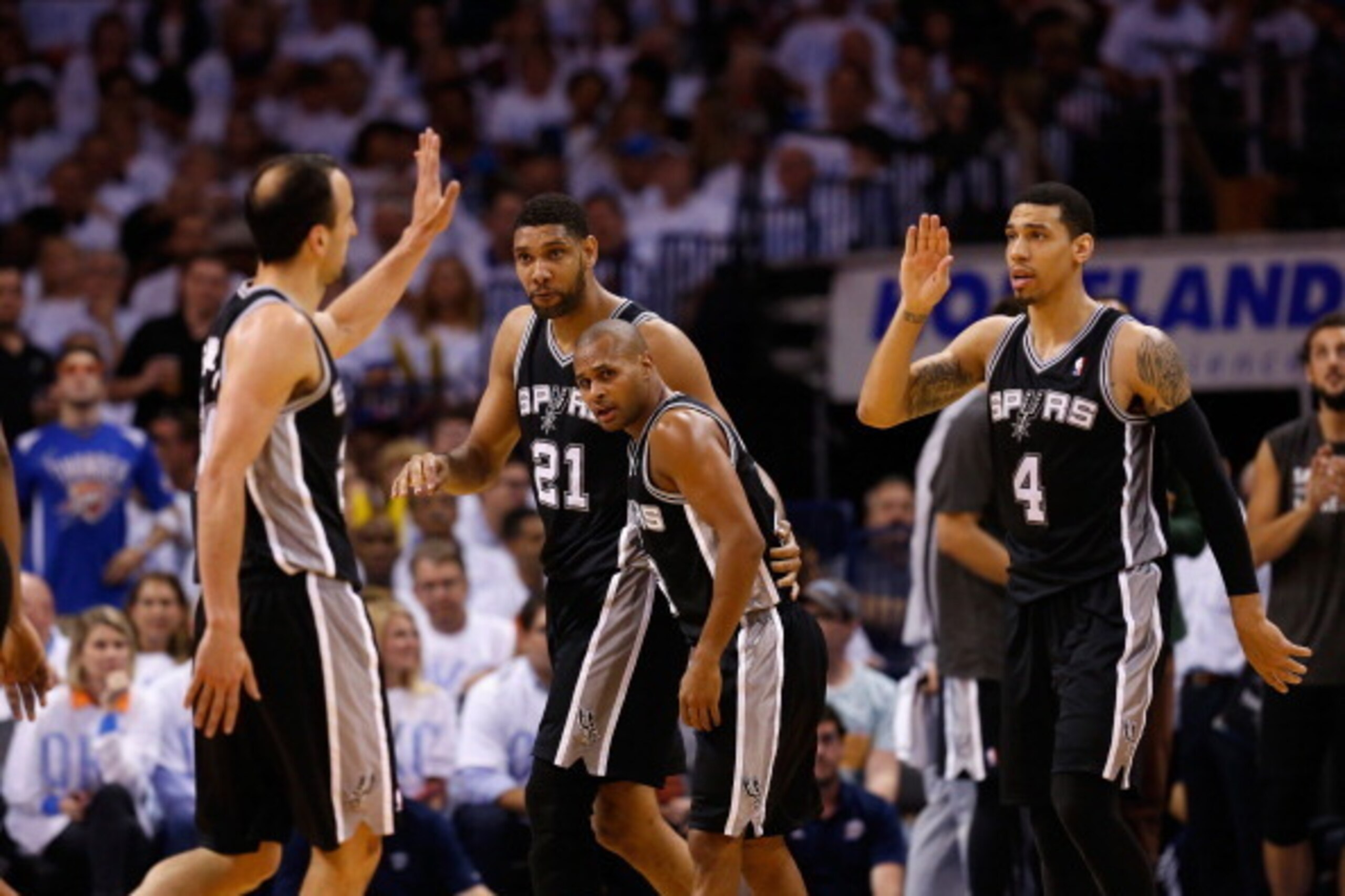 OKLAHOMA CITY, OK - MAY 31:  Manu Ginobili #20 and Danny Green #4  of the San Antonio Spurs celebrate with their teammates after a play against the Oklahoma City Thunder in the second half during Game Six of the Western Conference Finals of the 2014 NBA P