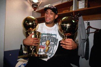 NEW YORK - JUNE 25:  Tim Duncan #21 of the San Antonio Spurs holds both the Larry O'Brien trophy and MVP Trophy in his lap following Game Five of the 1999 NBA Finals at Madison Square Garden on June 25, 1999 in New York, New York.   NOTE TO USER: User exp