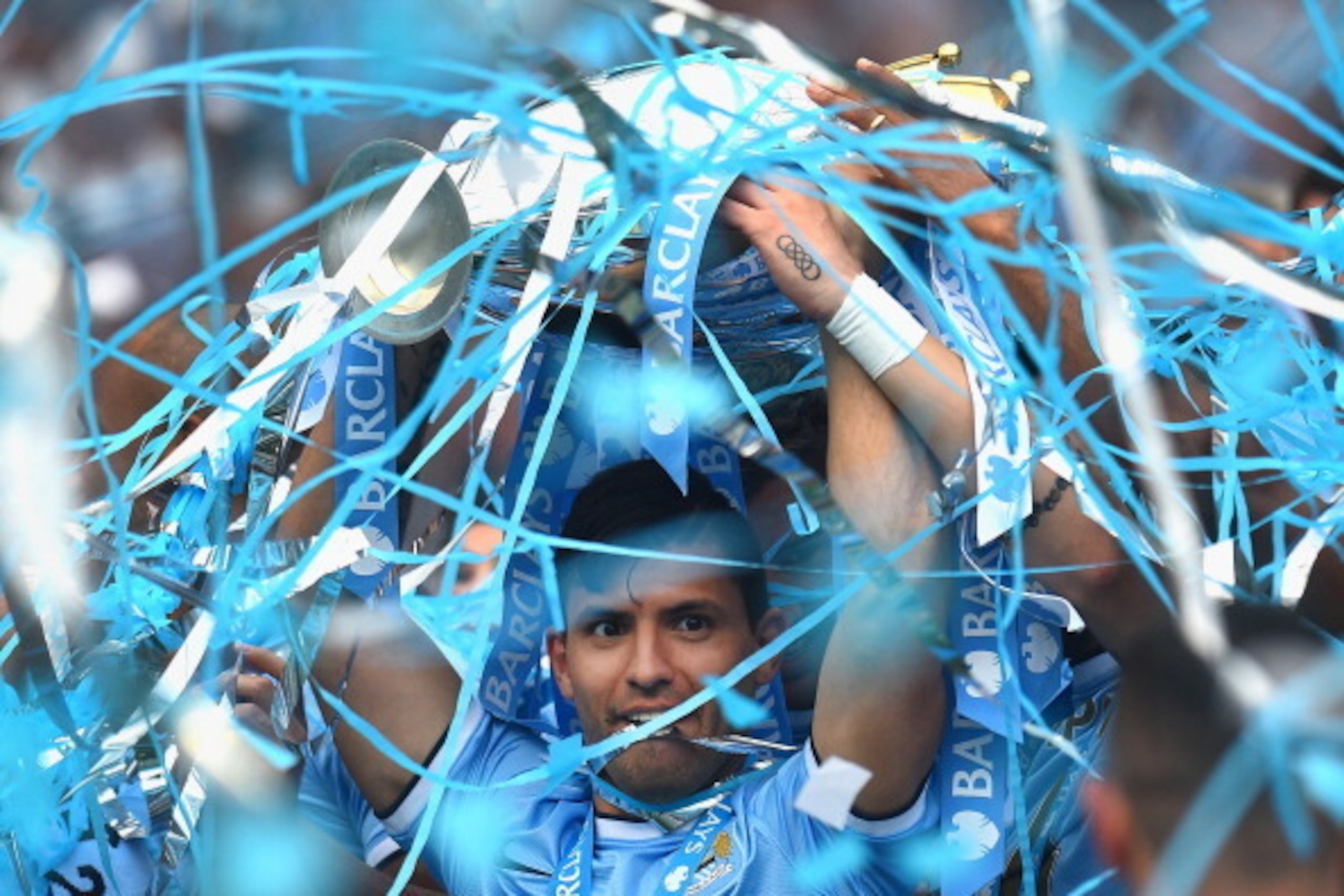 MANCHESTER, ENGLAND - MAY 11:  Sergio Aguero of Manchester City lifts the Premier League trophy at the end of the Barclays Premier League match between Manchester City and West Ham United  at Etihad Stadium on May 11, 2014 in Manchester, England.  (Photo 