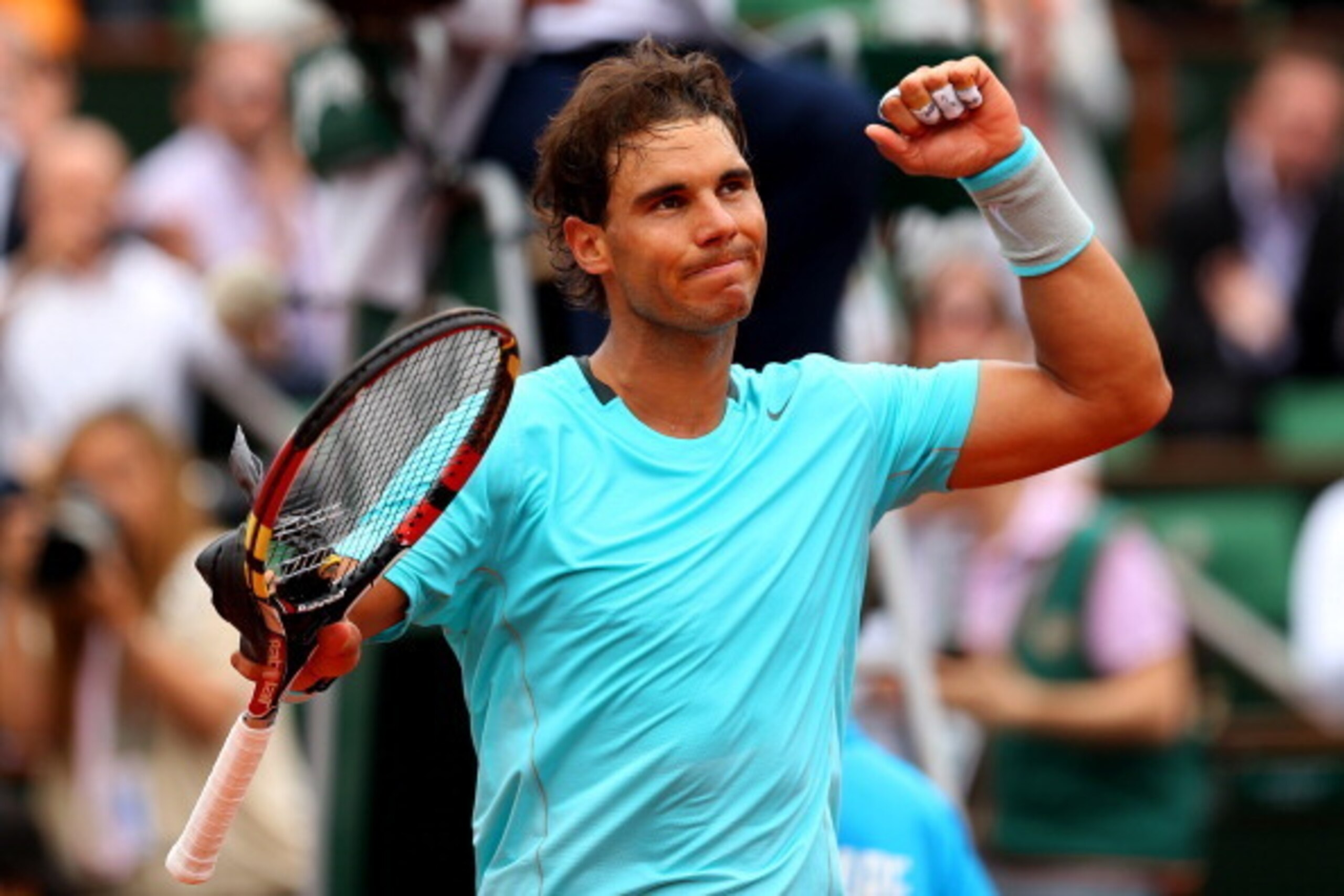PARIS, FRANCE - JUNE 02:  Rafael Nadal of Spain celebrates victory in his men's singles match against Dusan Lajovic of Serbia on day nine of the French Open at Roland Garros on June 2, 2014 in Paris, France.  (Photo by Clive Brunskill/Getty Images)