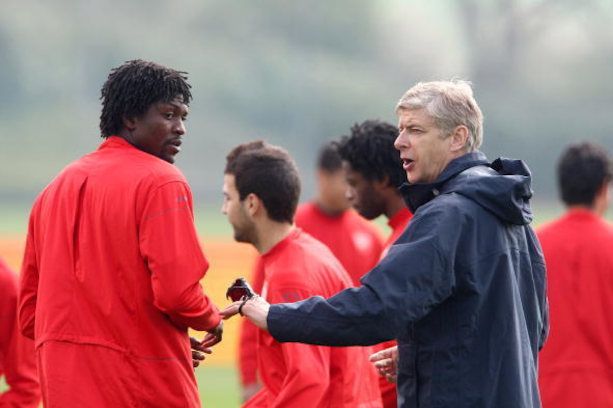 ST ALBANS, ENGLAND - APRIL 14:  Arsene Wenger Manager of Arsenal talks with Emmanuel Adebayor during a training session ahead of their UEFA Champions League Quarter Final second leg round match against Villarreal, at London Colney on April 14, 2009 in St 