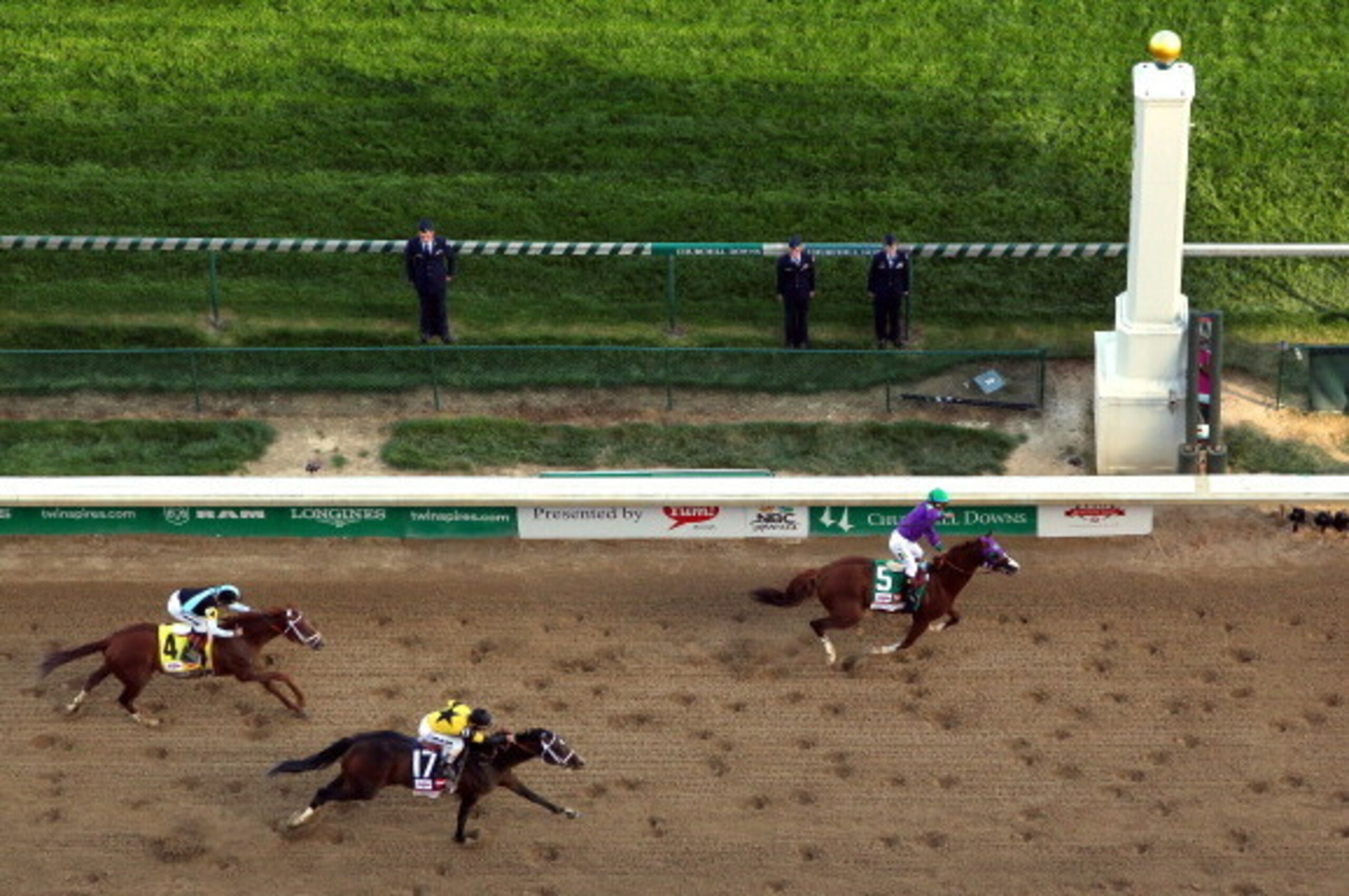 LOUISVILLE, KY - MAY 03:  California Chrome with Victor Espinoza up crosses the finish line ahead of Commanding Curve #17 and Danza #4 to win the 140th running of the Kentucky Derby at Churchill Downs on May 3, 2014 in Louisville, Kentucky.  (Photo by Jam