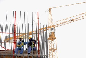 DOHA, QATAR - MAY 10:  Construction workers are pictured on a building site on May 10, 2014 in Doha, Qatar.  (Photo by Warren Little/Getty Images)