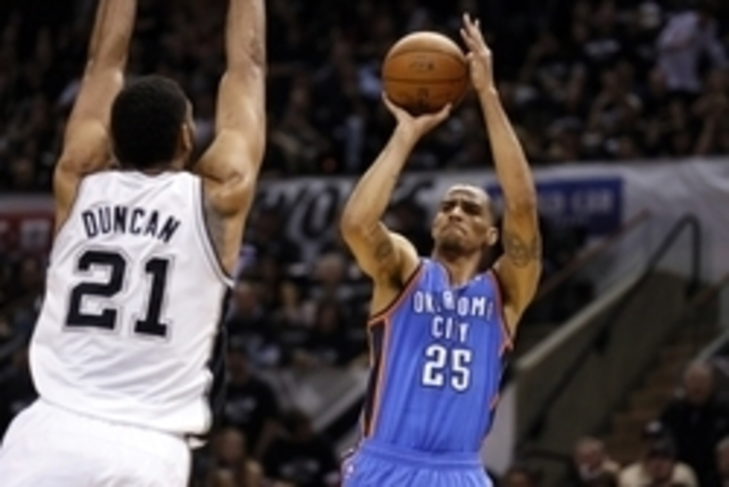 May 19, 2014; San Antonio, TX, USA; Oklahoma City Thunder guard Thabo Sefolosha (25) shoots the ball over San Antonio Spurs forward Tim Duncan (21) in game one of the Western Conference Finals in the 2014 NBA Playoffs at AT&T Center. Mandatory Credit: Soo