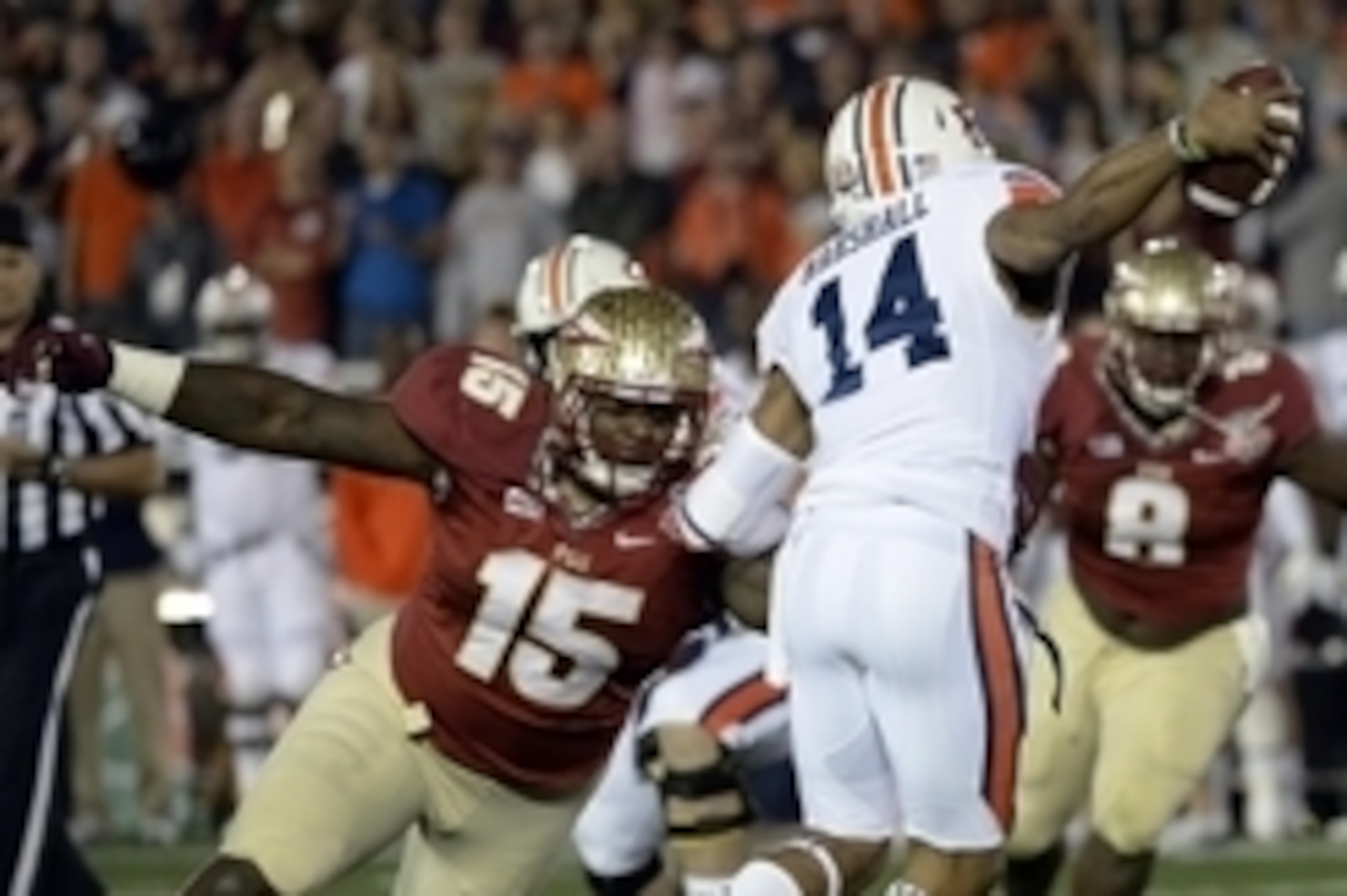 Jan 6, 2014; Pasadena, CA, USA; Florida State Seminoles defensive end Mario Edwards Jr. (15) tries to sack Auburn Tigers quarterback Nick Marshall (14) during the first half of the 2014 BCS National Championship game at the Rose Bowl.  Mandatory Credit: R