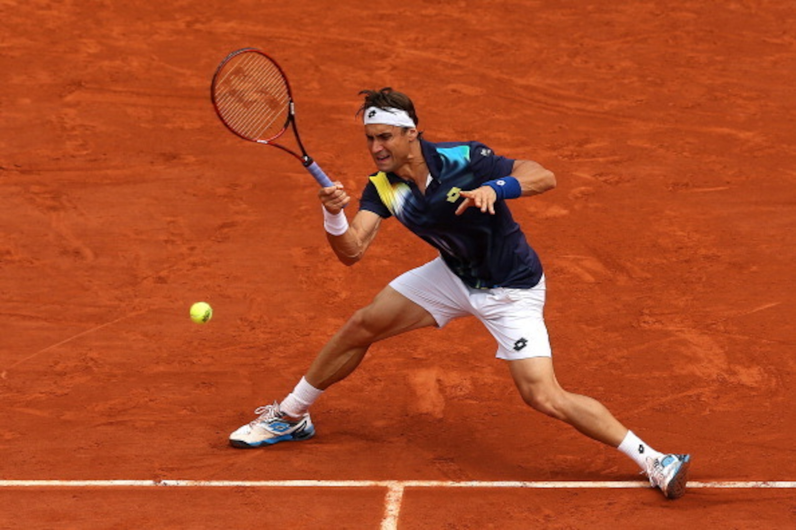 PARIS, FRANCE - JUNE 02:  David Ferrer of Spain returns a shot during his men's singles match against Kevin Anderson of South Africa on day nine of the French Open at Roland Garros on June 2, 2014 in Paris, France.  (Photo by Matthew Stockman/Getty Images