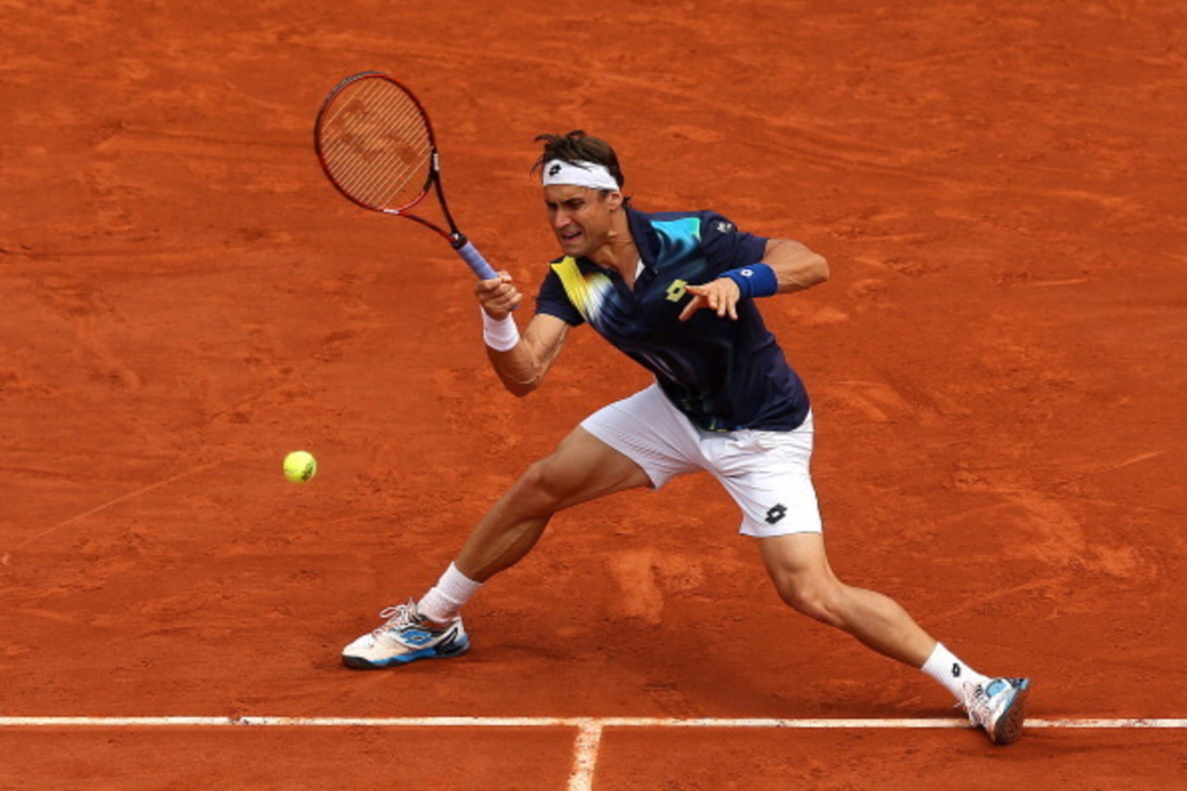 PARIS, FRANCE - JUNE 02:  David Ferrer of Spain returns a shot during his men's singles match against Kevin Anderson of South Africa on day nine of the French Open at Roland Garros on June 2, 2014 in Paris, France.  (Photo by Matthew Stockman/Getty Images
