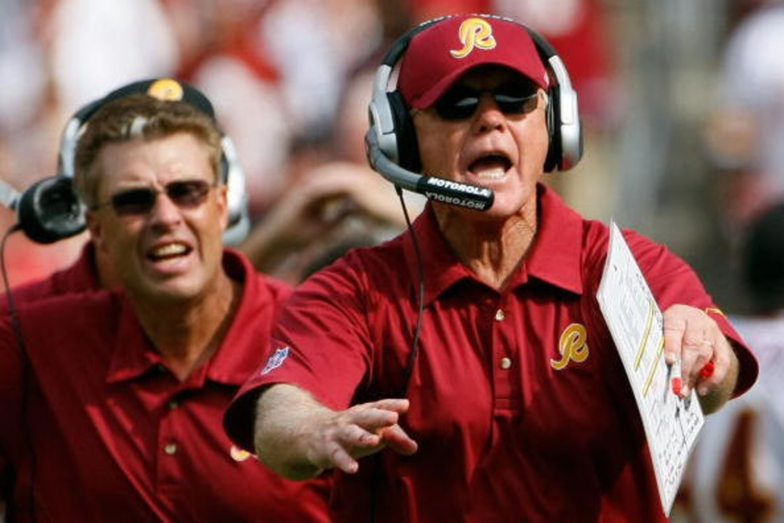 WASHINGTON - SEPTEMBER 09:  Washington Redskins head coach Joe Gibbs (R) and assistant head coach defense Gregg Williams (C) call for a timeout on the game winning drive in overtime against the Miami Dolphins at FedEx Field September 9, 2007 in Landover, 