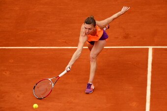 PARIS, FRANCE - JUNE 02:  Simona Halep of Romania returns a shot during her women's singles match against Sloane Stephens of the United States  on day nine of the French Open at Roland Garros on June 2, 2014 in Paris, France.  (Photo by Clive Brunskill/Ge