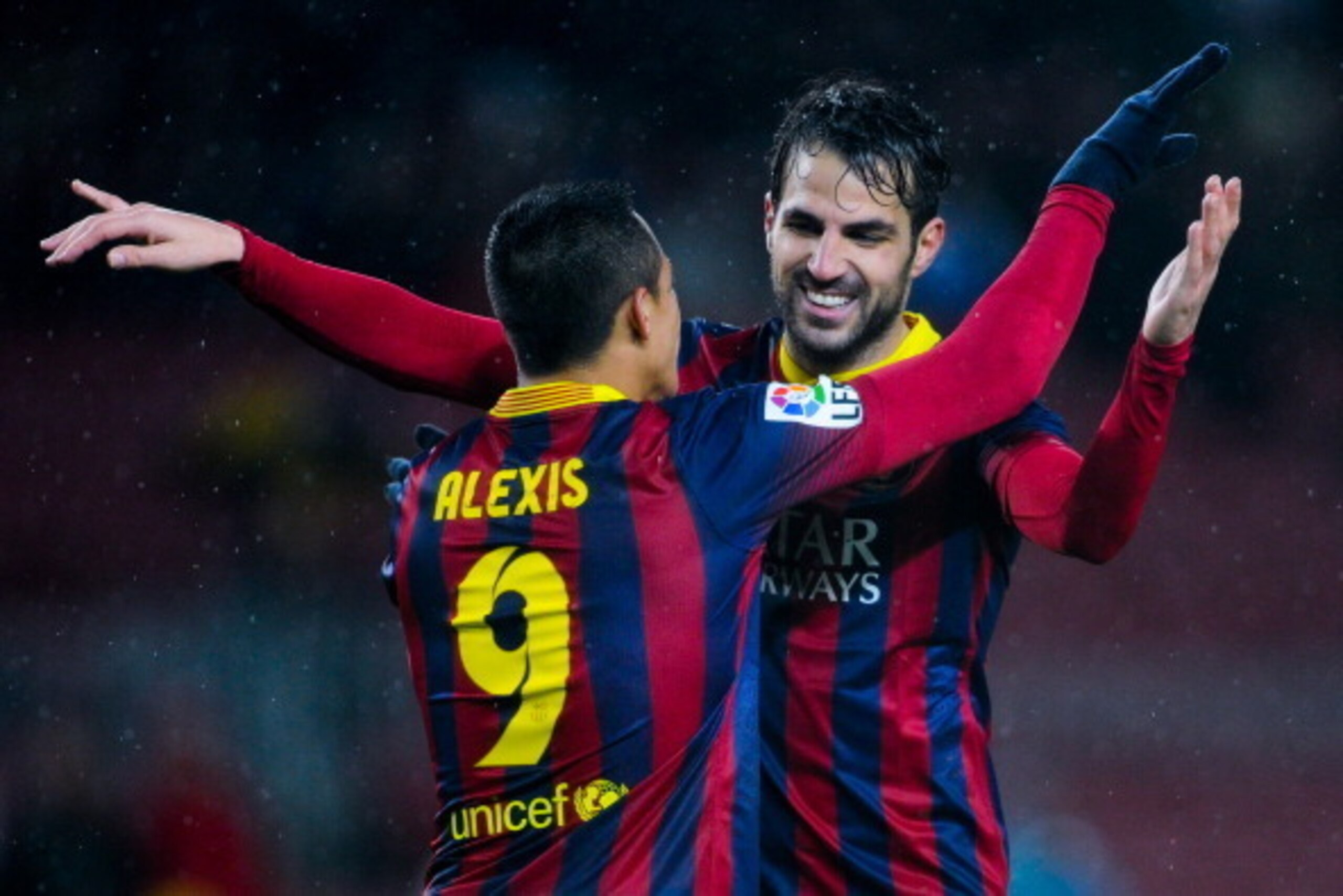 BARCELONA, SPAIN - JANUARY 29:  Cesc Fabregas (R) of FC Barcelona celebrates with his teammate Alexis Sanchez after scoring his team's fifth goal during the Copa del Rey Quarter Final 2nd leg match between FC Barcelona and Levante U.D Camp Nou on January 
