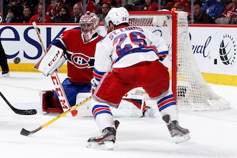 MONTREAL, QC - MAY 17:  Martin St. Louis #26 of the New York Rangers looks at the puck in front of goaltender Carey Price #31 of the Montreal Canadiens in the first period in Game One of the Eastern Conference Finals of the 2014 NHL Stanley Cup Playoffs a