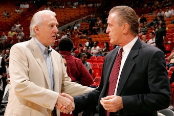 MIAMI - OCTOBER 23:  Head coach Gregg Popovich of the San Antonio Spurs greets head coach Pat Riley of the Miami Heat before the game at American Airlines Arena on October 23, 2007 in Miami, Florida.  The Spurs won 104-87.  NOTE TO USER: User expressly ac