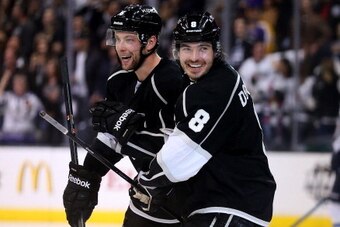 LOS ANGELES, CA - MARCH 29:  Drew Doughty #8 and Jake Muzzin #6 of the Los Angeles Kings celebrate after tyler Toffoli's third period goal against the Winnipeg Jets at Staples Center on March 29, 2014 in Los Angeles, California.  The Kings won 4-2.  (Phot