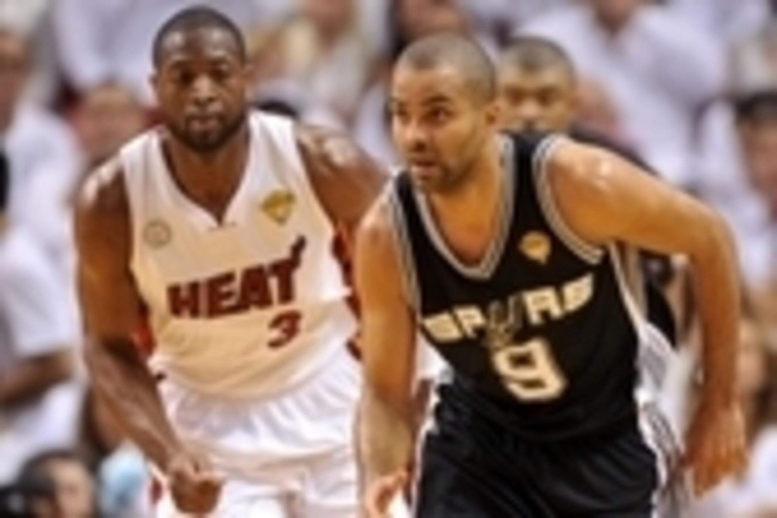 Jun 6, 2013; Miami, FL, USA; San Antonio Spurs point guard Tony Parker (9) dribbles  the ball past Miami Heat shooting guard Dwyane Wade (3) during the second quarter of game one of the 2013 NBA Finals at the American Airlines Arena. Mandatory Credit: Ste