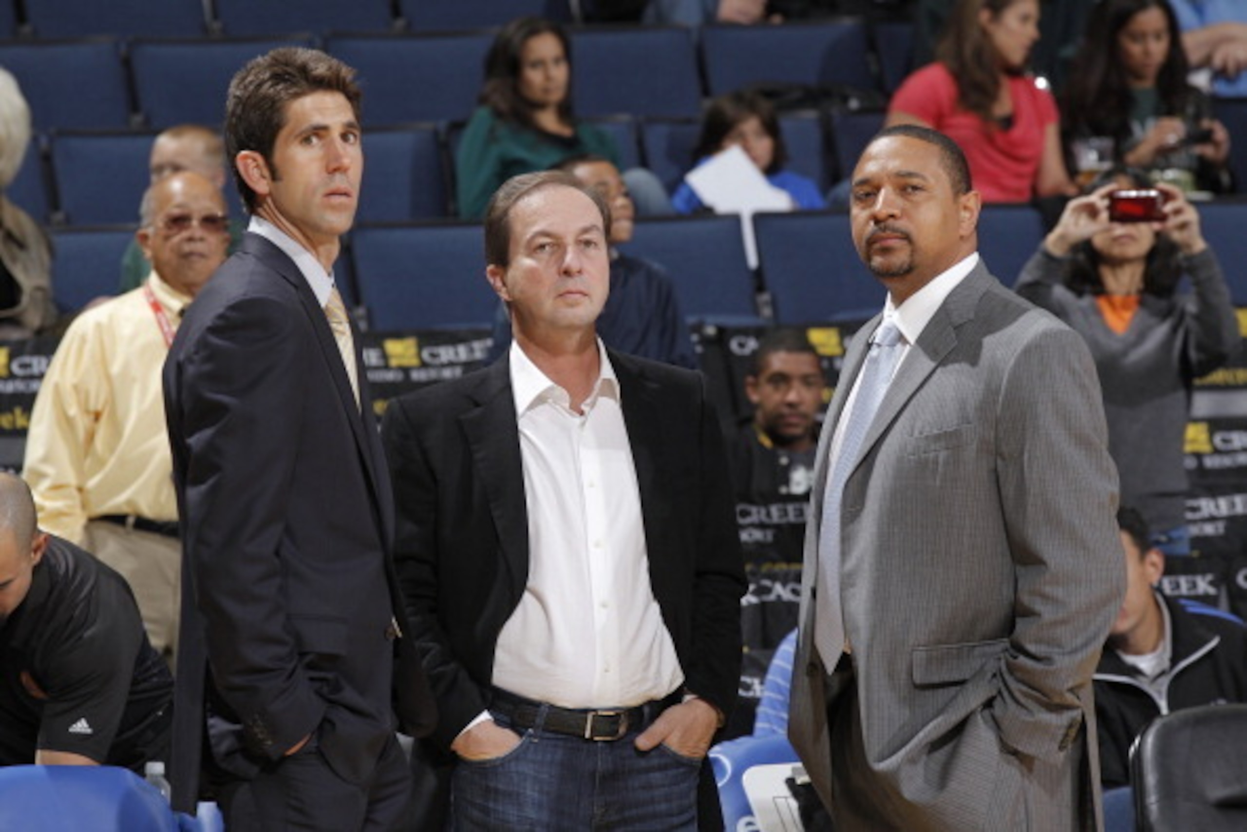 OAKLAND, CA - OCTOBER 11: Bob Myers, Joe Lacob, and Mark Jackson chat on the sideline during a game against the Maccabi Haifa on October 11, 2012 at Oracle Arena in Oakland, California. NOTE TO USER: User expressly acknowledges and agrees that, by downloa