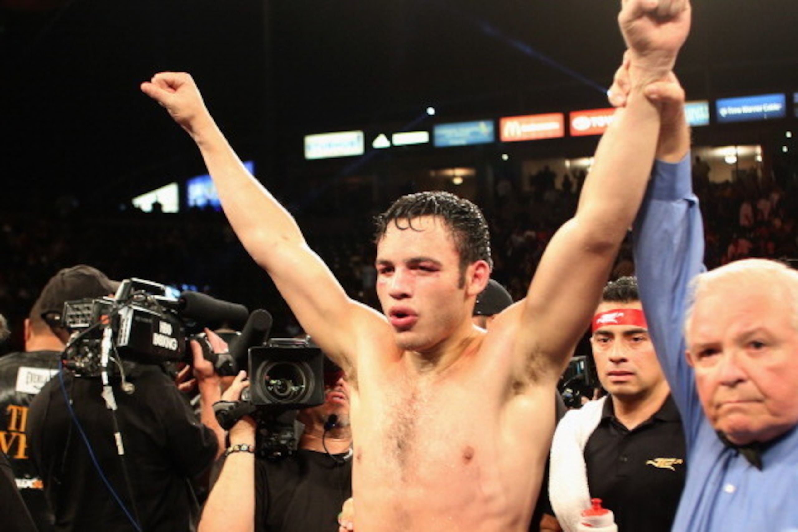 LOS ANGELES, CA - SEPTEMBER 28:  Julio Cesar Chavez Jr. celebrates his Light Heavyweight bout victory over Brian Vera next to referee Lou Moret at StubHub Center on September 28, 2013 in Los Angeles, California.  (Photo by Jeff Gross/Getty Images)