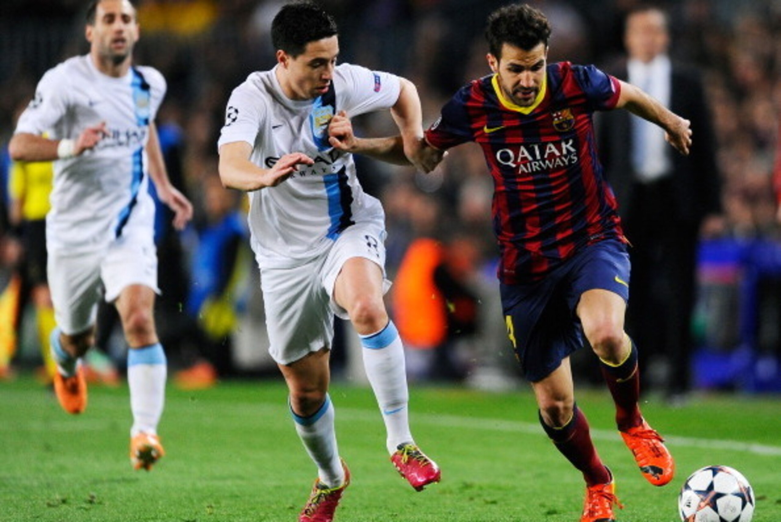 BARCELONA, SPAIN - MARCH 12:  Cesc Fabregas of Barcelona holds off Samir Nasri of Manchester City during the UEFA Champions League Round of 16, second leg match between FC Barcelona and Manchester City  at Camp Nou on March 12, 2014 in Barcelona, Spain.  
