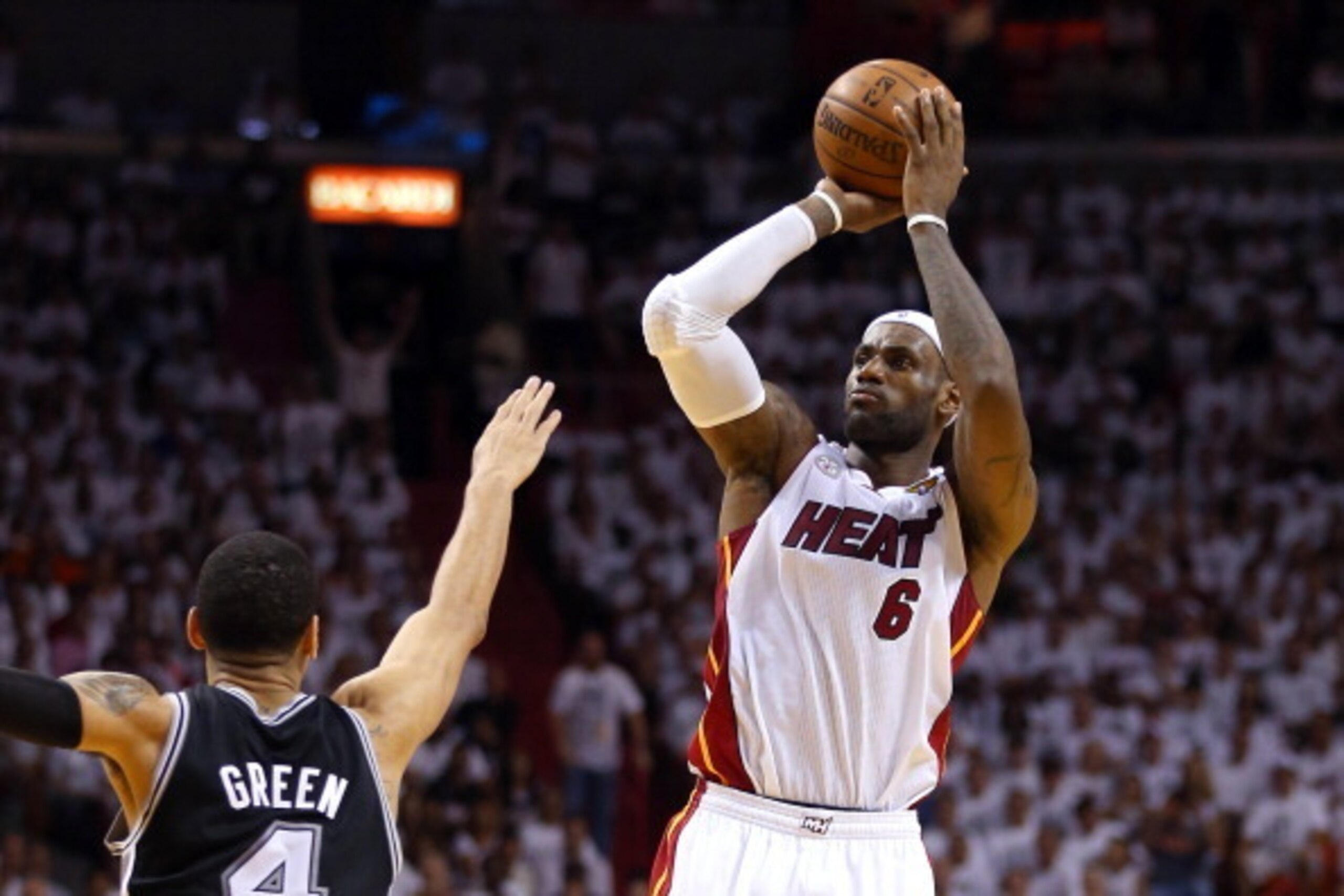 MIAMI, FL - JUNE 20:  LeBron James #6 of the Miami Heat makes a three-pointer over Danny Green #4 of the San Antonio Spurs in the second quarter during Game Seven of the 2013 NBA Finals at AmericanAirlines Arena on June 20, 2013 in Miami, Florida. NOTE TO