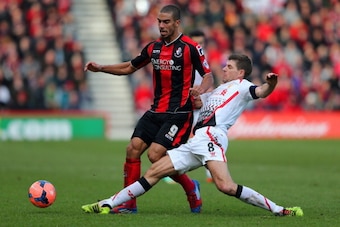 BOURNEMOUTH, ENGLAND - JANUARY 25:  Steven Gerrard of Liverpool tackles Lewis Grabban of Bournemouth during the FA Cup Fourth Round match between Bournemouth and Liverpool at Goldsands Stadium on January 25, 2014 in Bournemouth, England.  (Photo by Ian Wa