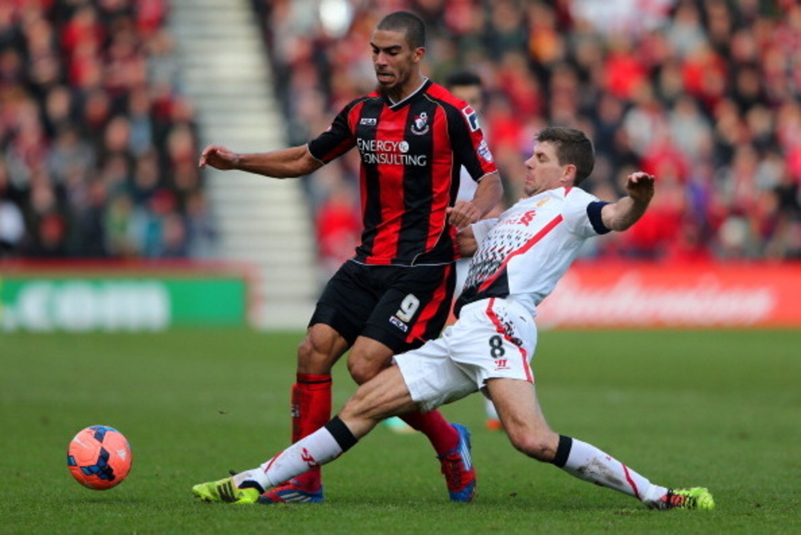 BOURNEMOUTH, ENGLAND - JANUARY 25:  Steven Gerrard of Liverpool tackles Lewis Grabban of Bournemouth during the FA Cup Fourth Round match between Bournemouth and Liverpool at Goldsands Stadium on January 25, 2014 in Bournemouth, England.  (Photo by Ian Wa