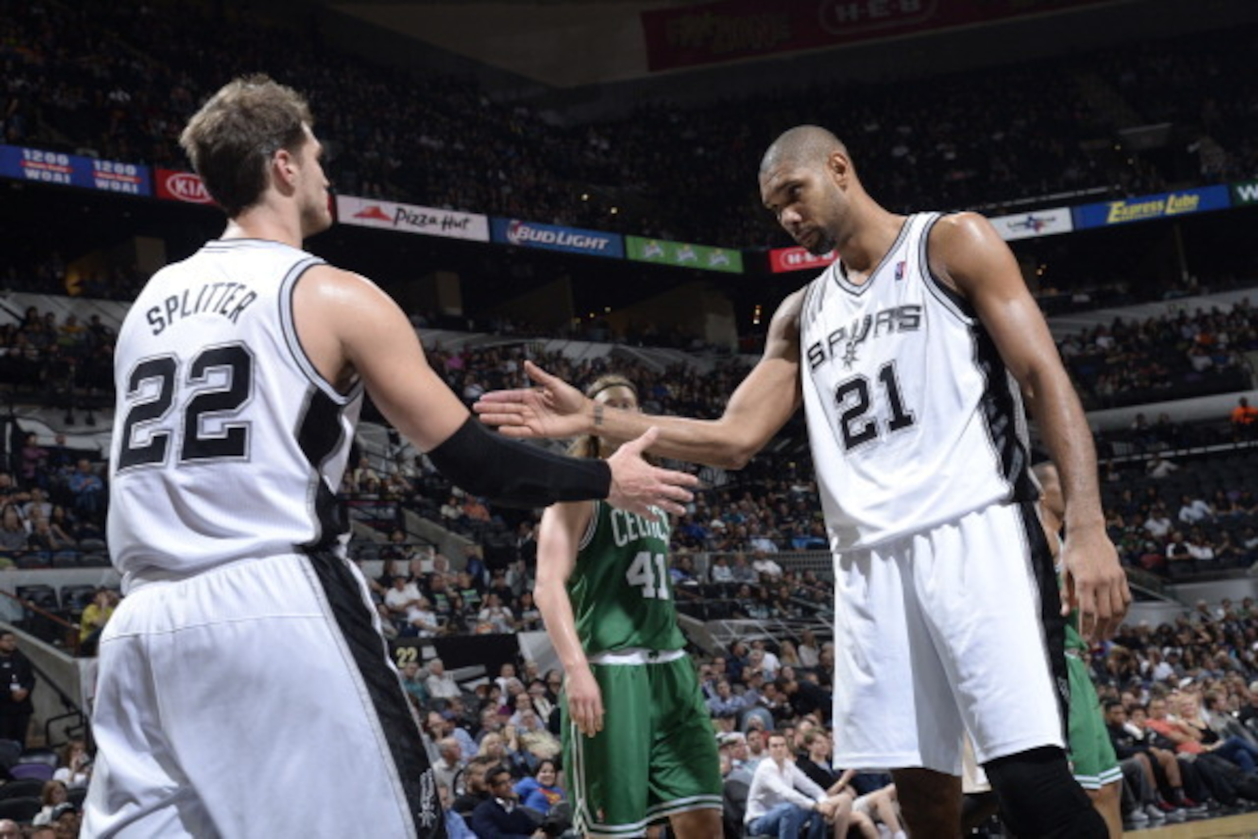 SAN ANTONIO, TX - November 20: Tiago Splitter #22 and Tim Duncan #21 of the San Antonio Spurs celebrate during the game against the Boston Celtics at the AT&T Center on November 20, 2013 in San Antonio, Texas. NOTE TO USER: User expressly acknowledges and