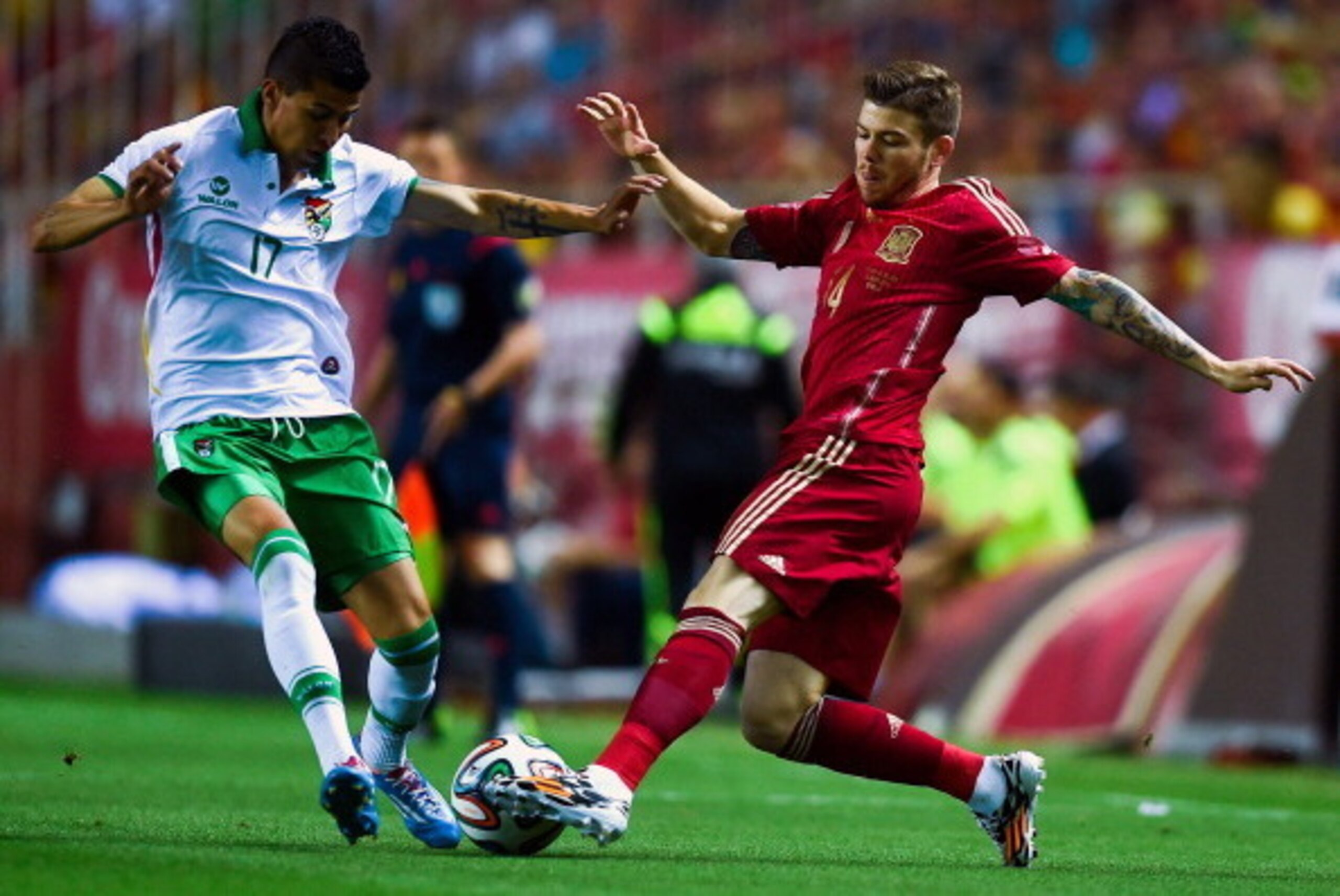 SEVILLE, SPAIN - MAY 30:  Alberto Moreno of Spain competes for the ball with Juan Carlos Arce of Bolivia an international friendly match between Spain and Bolivia at Estadio Ramon Sanchez Pizjuan on May 30, 2014 in Seville, Spain.  (Photo by David Ramos/G