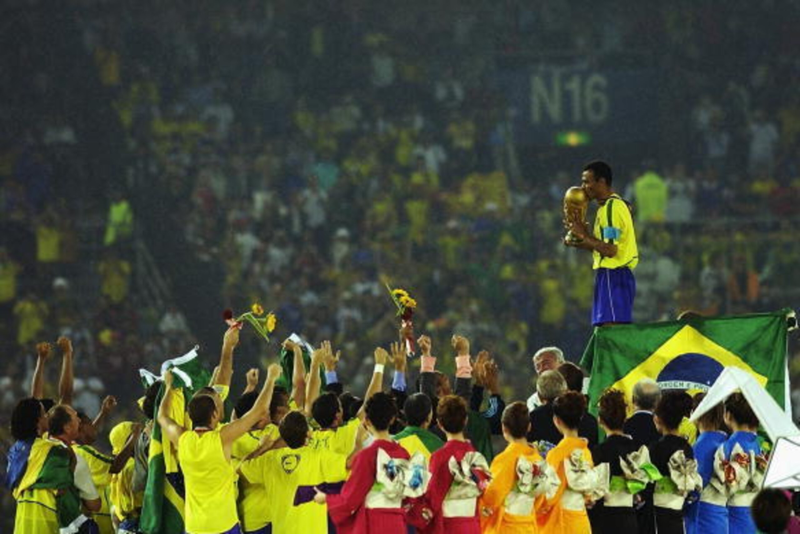 YOKOHAMA - JUNE 30: Cafu on the podium celebrates with the World Cup trophy after the World Cup Final match against Germany played at the International Stadium Yokohama, Yokohama, Japan on June 30, 2002. Brazil won the match 2-0. (Photo by Shaun Botteri YOKOHAMA - JUNE 30: Cafu on the podium celebrates with the World Cup trophy after the World Cup Final match against Germany played at the International Stadium Yokohama, Yokohama, Japan on June 30, 2002. Brazil won the match 2-0. (Photo by Shaun Botteri