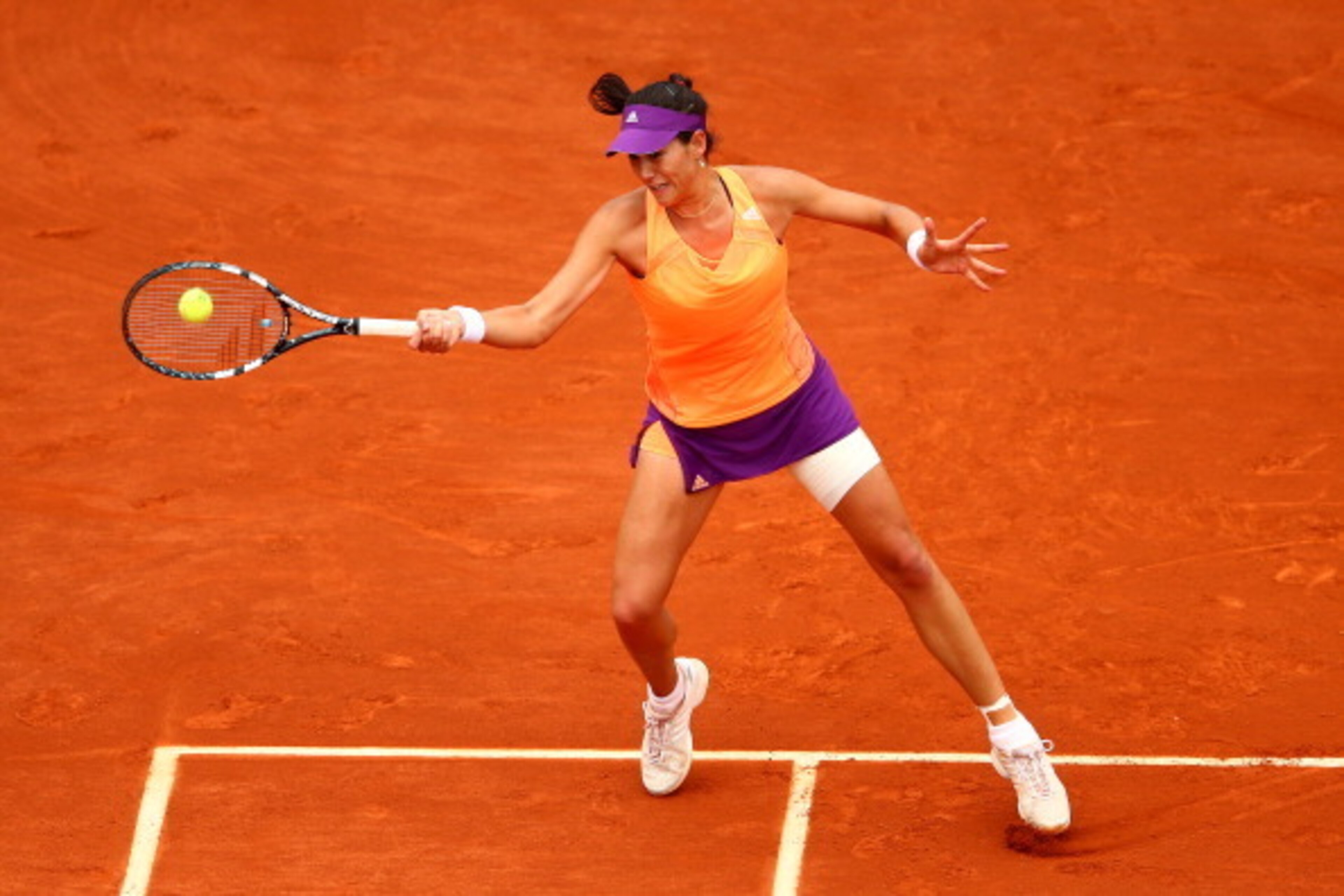 PARIS, FRANCE - JUNE 03:  Garbine Muguruza of Spain returns a shot during her women's singles quarter-final match against Maria Sharapova of Russia on day ten of the French Open at Roland Garros on June 3, 2014 in Paris, France.  (Photo by Clive Brunskill