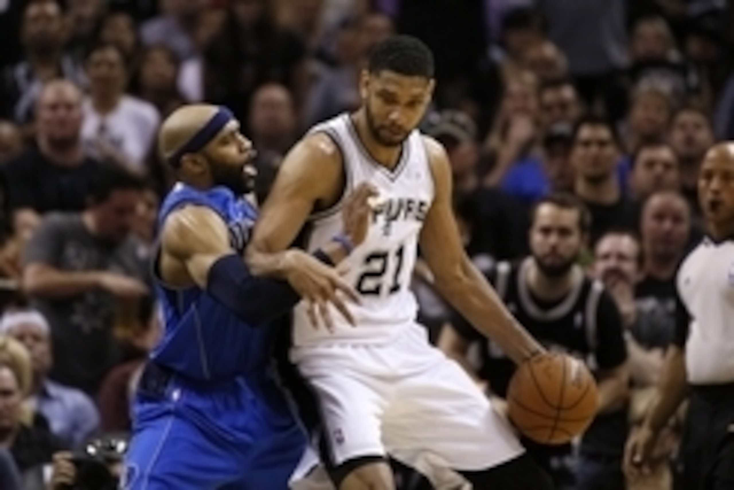 May 4, 2014; San Antonio, TX, USA; San Antonio Spurs forward Tim Duncan (21) posts up against Dallas Mavericks guard Vince Carter (left) in game seven of the first round of the 2014 NBA Playoffs at AT&T Center. The Spurs won 119-96. Mandatory Credit: Soob