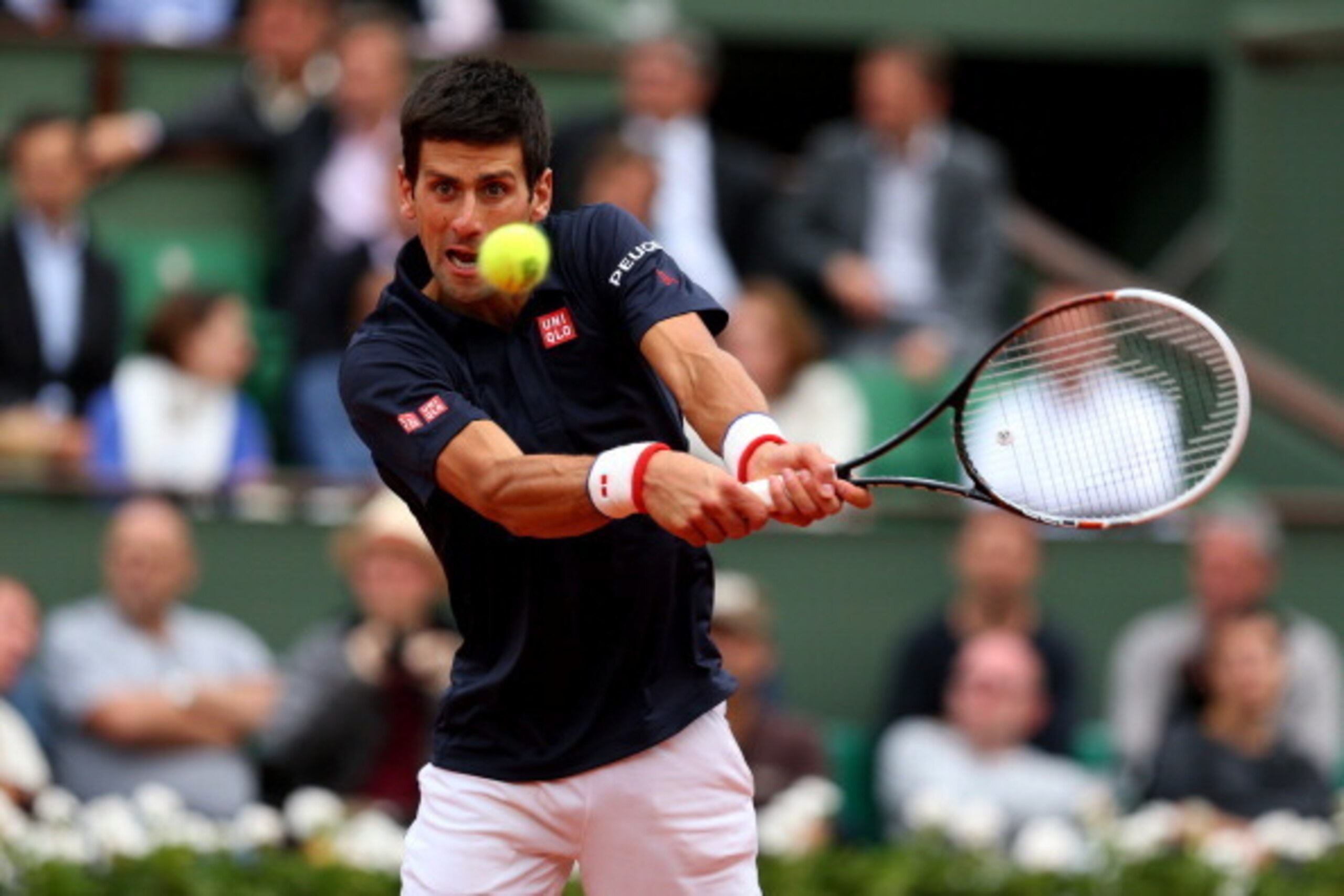 PARIS, FRANCE - JUNE 03:  Novak Djokovic of Serbia returns a shot during his men's singles match against Milos Raonic of Canada on day ten of the French Open at Roland Garros on June 3, 2014 in Paris, France.  (Photo by Clive Brunskill/Getty Images)