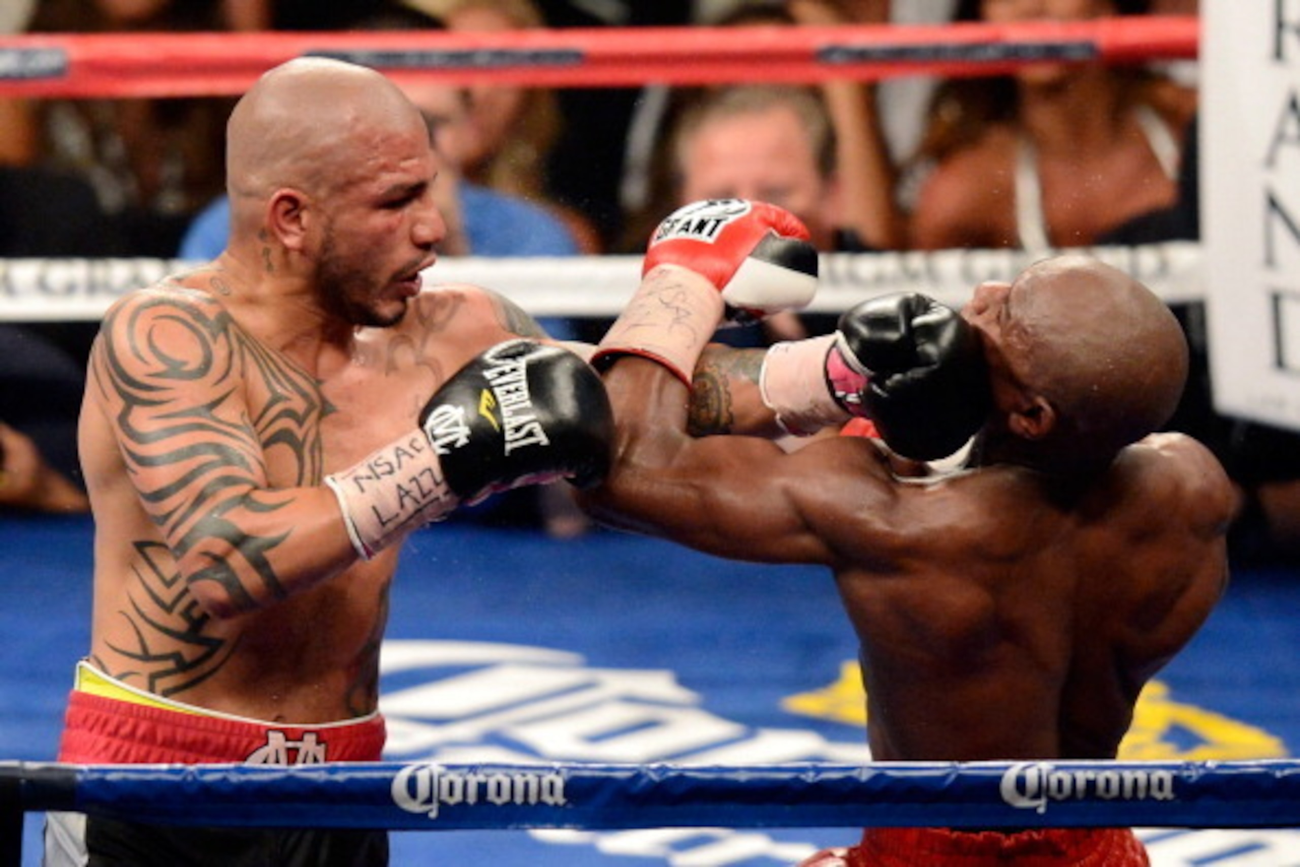 LAS VEGAS, NV - MAY 05: Miguel Cotto (L) hits Floyd Mayweather Jr. during the 12th round of their WBA super welterweight title fight at the MGM Grand Garden Arena May 5, 2012 in Las Vegas, Nevada. Mayweather won by unanimous decision. (Photo by Ethan Mi LAS VEGAS, NV - MAY 05: Miguel Cotto (L) hits Floyd Mayweather Jr. during the 12th round of their WBA super welterweight title fight at the MGM Grand Garden Arena May 5, 2012 in Las Vegas, Nevada. Mayweather won by unanimous decision. (Photo by Ethan Mi