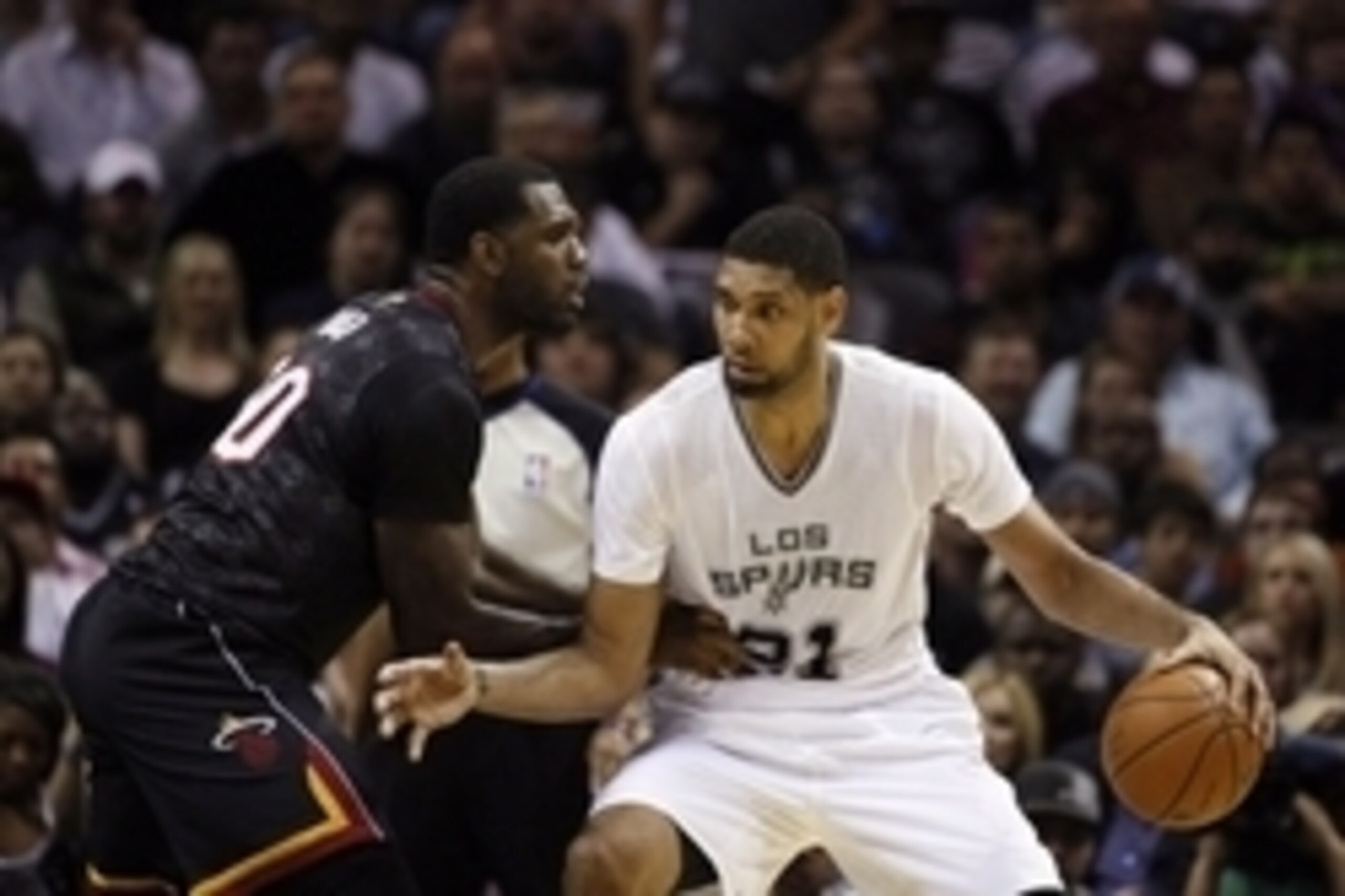 Mar 6, 2014; San Antonio, TX, USA; San Antonio Spurs forward Tim Duncan (21) is defended by Miami Heat center Greg Oden (20) during the first half at AT&T Center. Mandatory Credit: Soobum Im-USA TODAY Sports