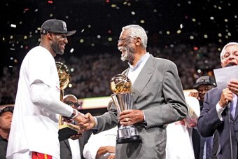 MIAMI, FL - JUNE 20: LeBron James #6 of the Miami Heat receives the Bill Russell NBA Finals Most Valuable Player (MVP) trophy from NBA legend Bill Russell following the Heat's victory against the San Antonio Spurs in Game Seven of the 2013 NBA Finals on J
