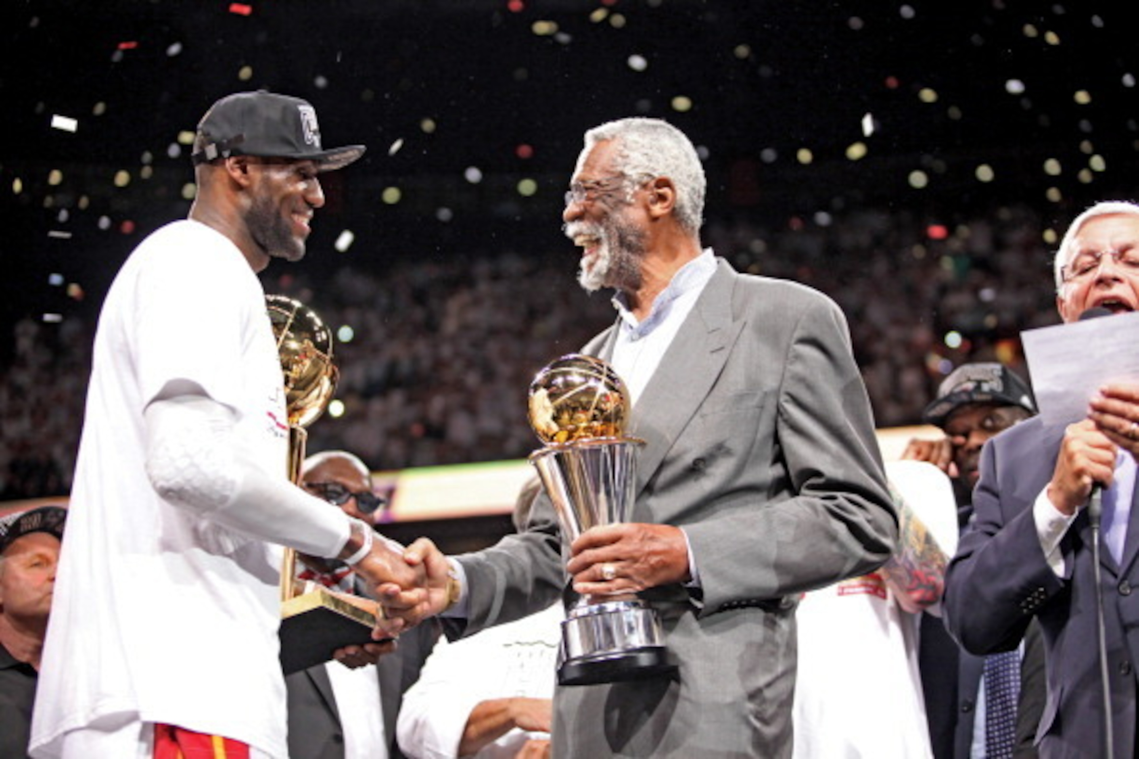 MIAMI, FL - JUNE 20: LeBron James #6 of the Miami Heat receives the Bill Russell NBA Finals Most Valuable Player (MVP) trophy from NBA legend Bill Russell following the Heat's victory against the San Antonio Spurs in Game Seven of the 2013 NBA Finals on J