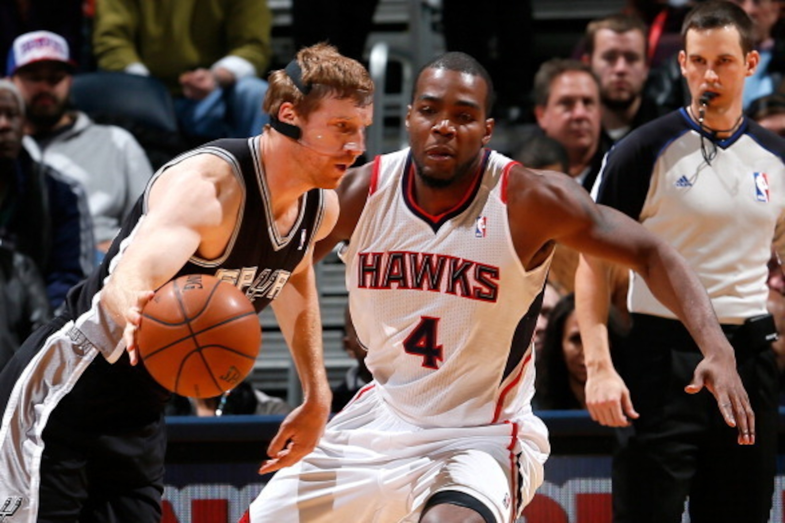 ATLANTA, GA - JANUARY 24:  Matt Bonner #15 of the San Antonio Spurs drives against Paul Millsap #4 of the Atlanta Hawks at Philips Arena on January 24, 2014 in Atlanta, Georgia.  NOTE TO USER: User expressly acknowledges and agrees that, by downloading an