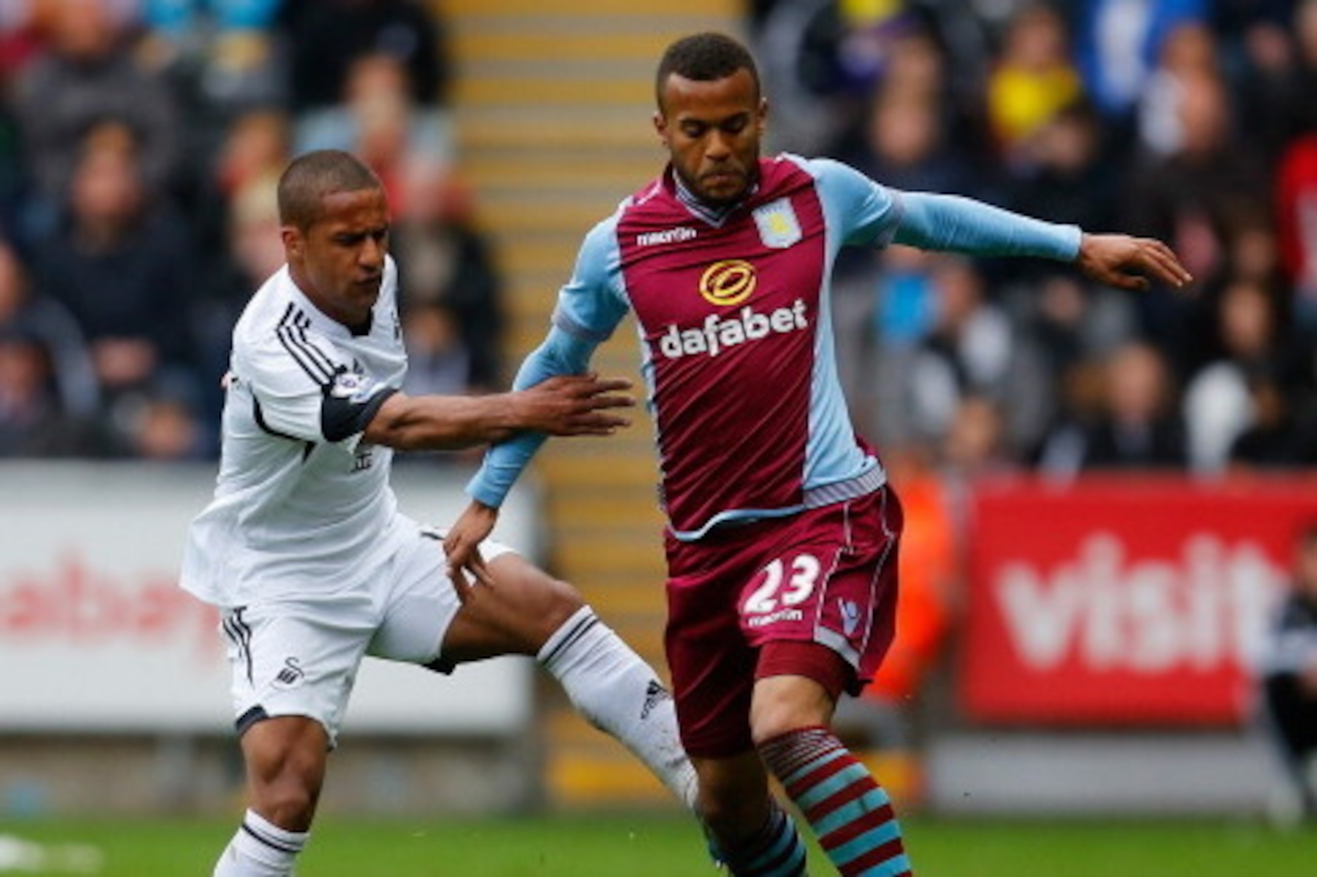 SWANSEA, WALES - APRIL 26:  Wayne Routledge of Swansea City battles with Ryan Bertrand of Aston Villa during the Barclays Premier League match between Swansea City and Aston Villa at Liberty Stadium on April 26, 2014 in Swansea, Wales.  (Photo by Paul Tho