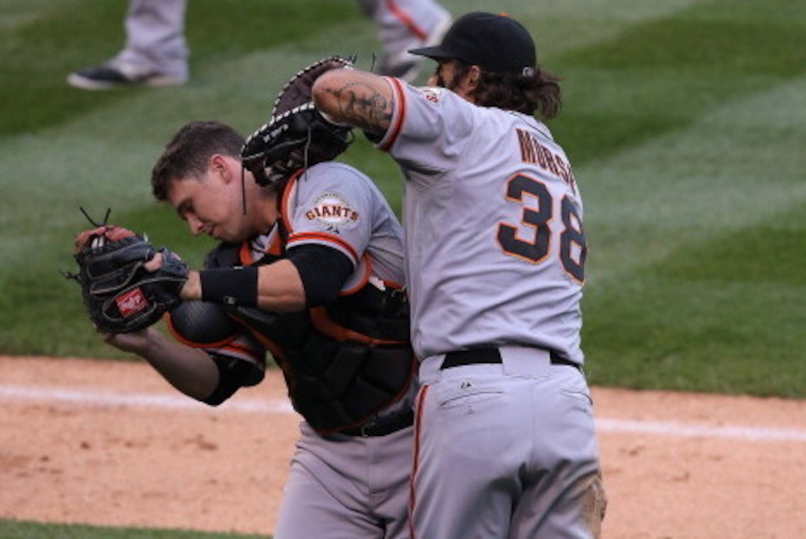 DENVER, CO - MAY 22:  Catcher Buster Posey #28 of the San Francisco Giants collides with first baseman Michael Morse #38 of the San Francisco Giants as Posey catches a pop foul by Justin Morneau #33 of the Colorado Rockies to end the fourth inning at Coor