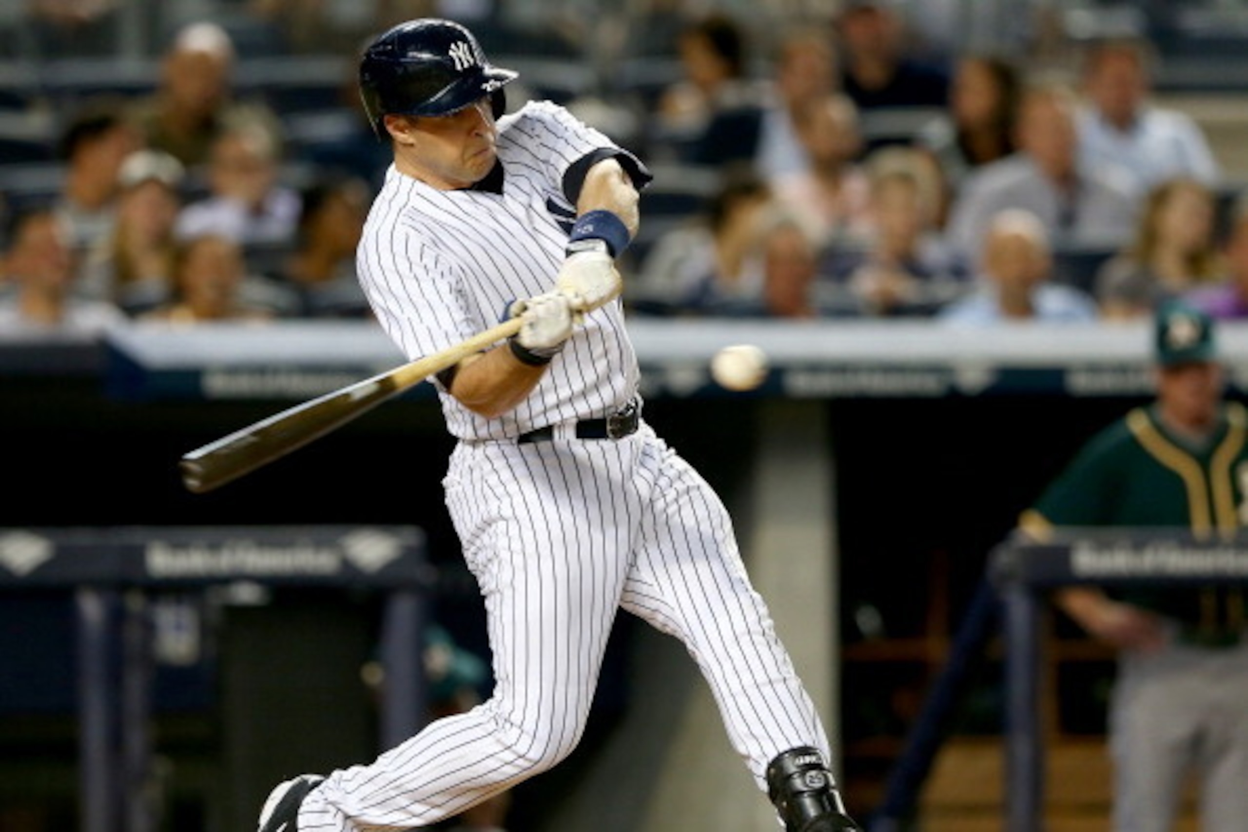 NEW YORK, NY - JUNE 03:  Mark Teixeira #25 of the New York Yankees hits an RBI single in the first inning against the Oakland Athletics on June 3, 2014 at Yankee Stadium in the Bronx borough of New York City.  (Photo by Elsa/Getty Images)