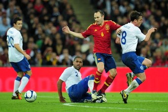 LONDON, ENGLAND - NOVEMBER 12:  Andres Iniesta of Spain takes on Stewart Downing, Glen Johnson and Scott Parker of England during the international friendly match between England and Spain at Wembley Stadium on November 12, 2011 in London, England.  (Phot