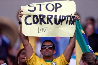 BELO HORIZONTE, BRAZIL - JUNE 22:  A fan holds up a sign reading 'Stop Corruption' during the FIFA Confederations Cup Brazil 2013 Group A match between Japan and Mexico at Estadio Mineirao on June 22, 2013 in Belo Horizonte, Brazil.  (Photo by Ronald Mart