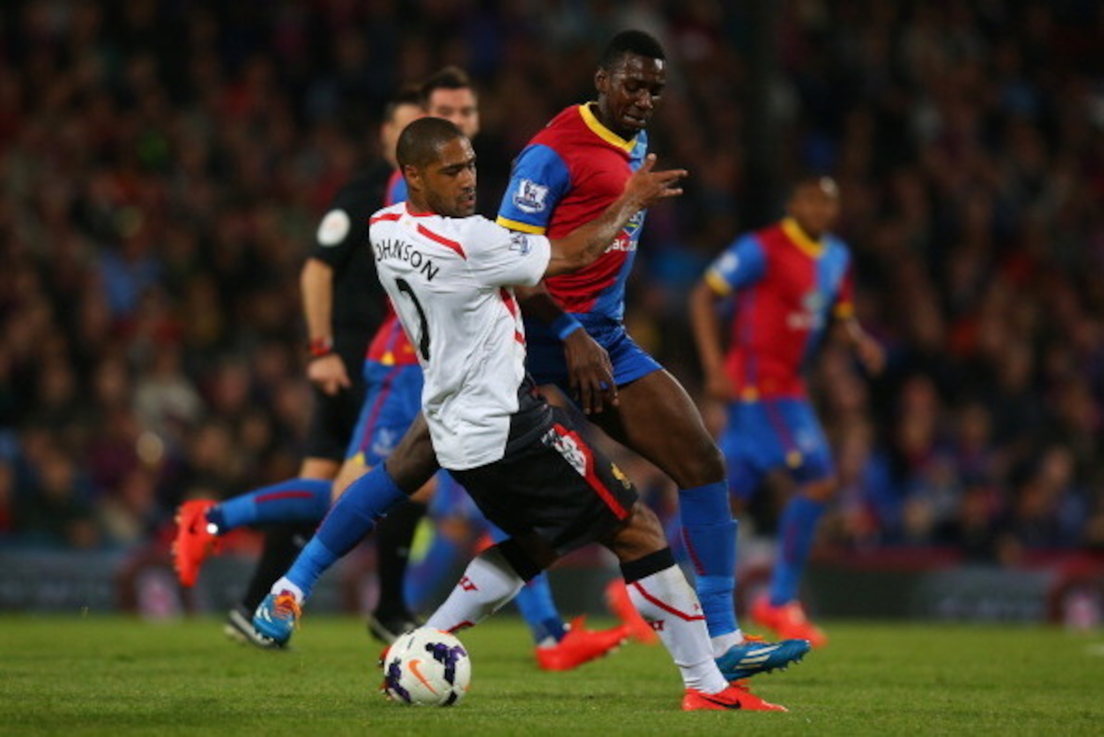 LONDON, ENGLAND - MAY 05:  Glen Johnson of Liverpool and Yannick Bolasie of Crystal Palace compete for the ball during the Barclays Premier League match between Crystal Palace and Liverpool at Selhurst Park on May 5, 2014 in London, England.  (Photo by Cl