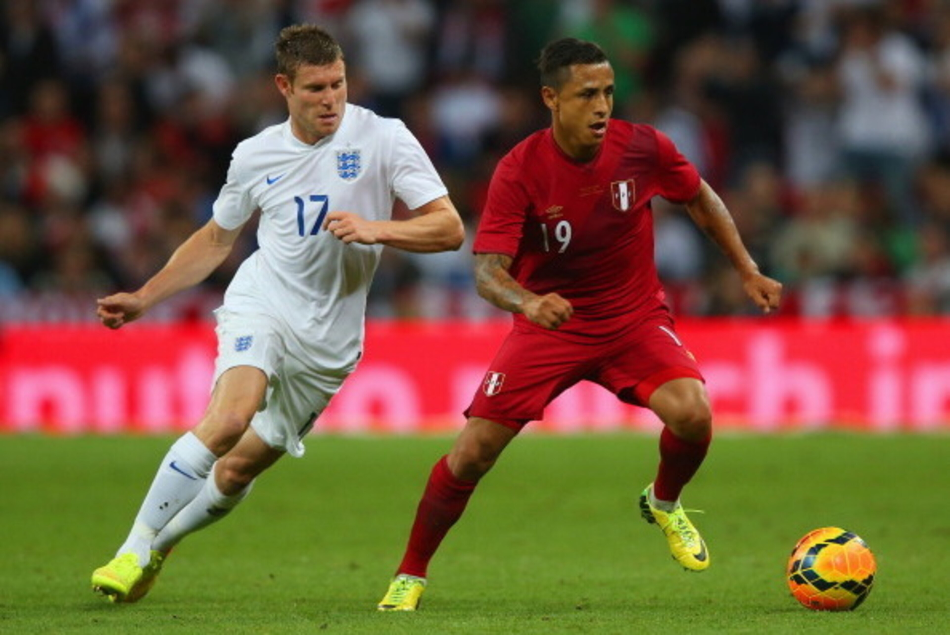 LONDON, ENGLAND - MAY 30: James Milner of England marshalls Yoshimar Yotun of Peru  during the international friendly match between England and Peru at Wembley Stadium on May 30, 2014 in London, England.  (Photo by Clive Rose/Getty Images)