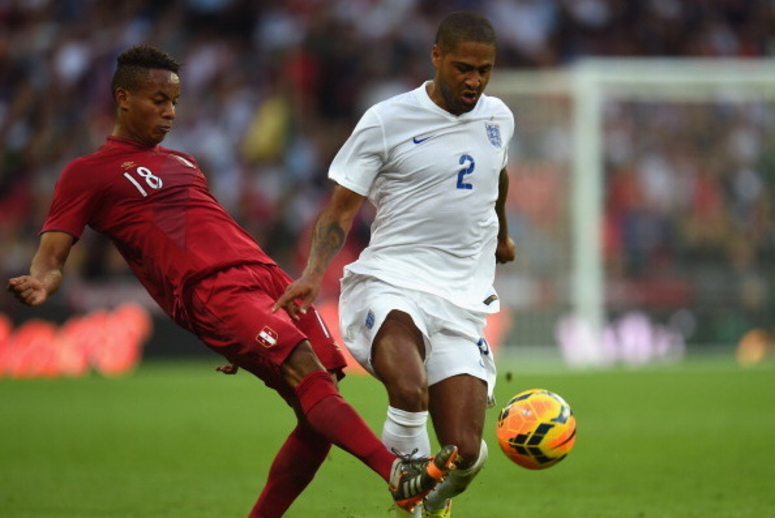 LONDON, ENGLAND - MAY 30:  Andre Carrillo of Peru and Glen Johnson of England battle for the ball during the international friendly match between England and Peru at Wembley Stadium on May 30, 2014 in London, England.  (Photo by Shaun Botterill/Getty Imag
