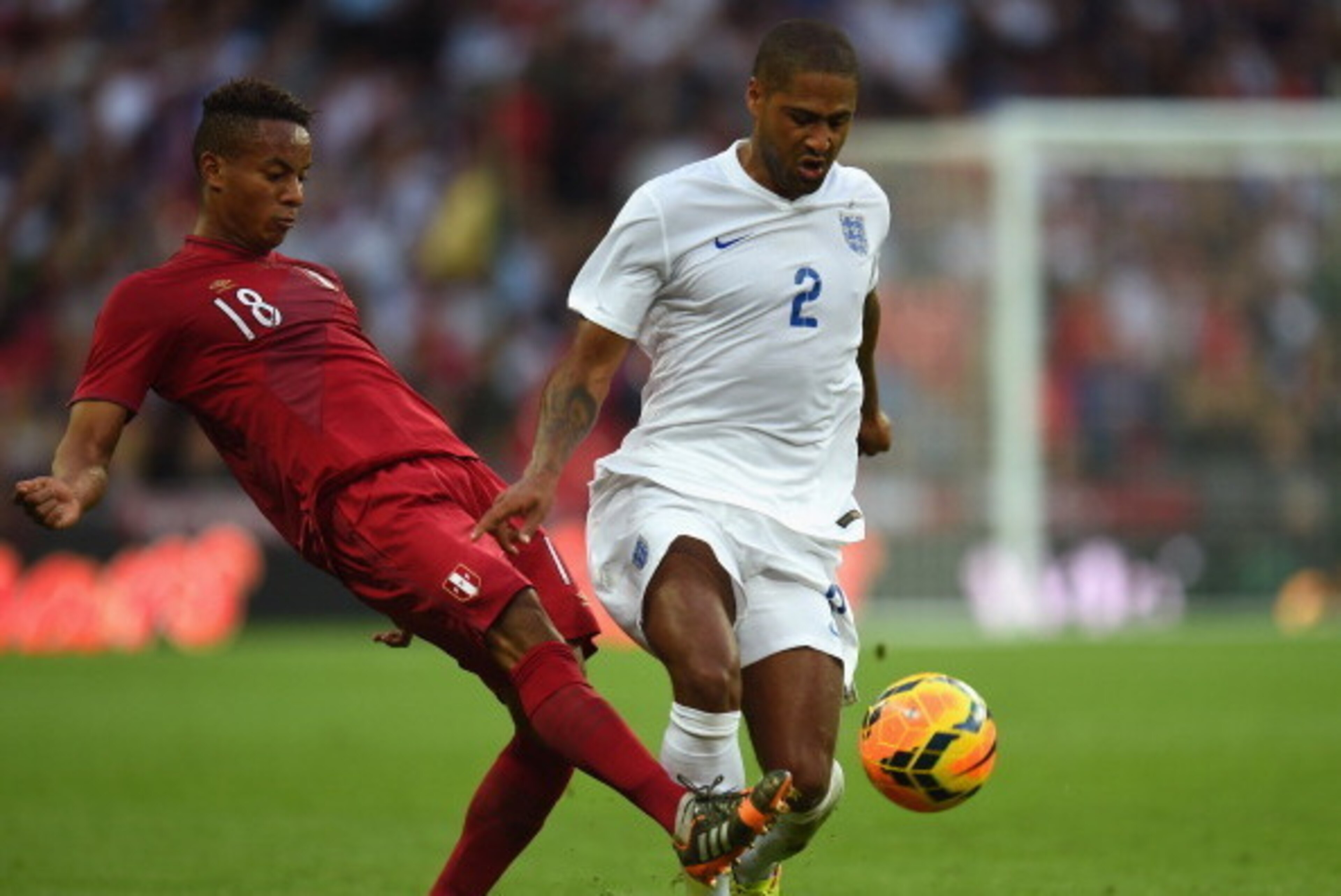 LONDON, ENGLAND - MAY 30:  Andre Carrillo of Peru and Glen Johnson of England battle for the ball during the international friendly match between England and Peru at Wembley Stadium on May 30, 2014 in London, England.  (Photo by Shaun Botterill/Getty Imag