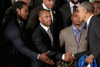 WASHINGTON, DC - MAY 21:  U.S. President Barack Obama (R) congratulates Seattle Seahawks players (L-R) Richard Sherman, Russell Wilson and Doug Baldwin during a ceremony honoring the players, coaches and executives of the Super Bowl XLVIII champions in th